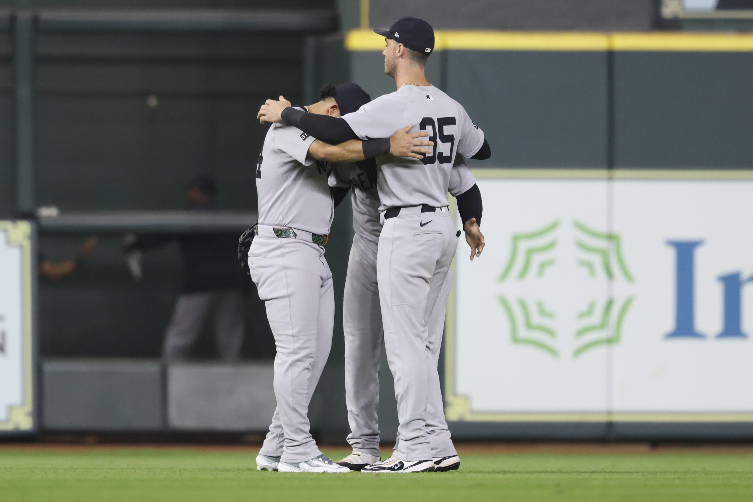 Sep 2, 2025; Houston, Texas, USA; New York Yankees left fielder Jasson Dominguez (24) and center fielder Trent Grisham (12) and right fielder Cody Bellinger (35) celebrate after the game against the Houston Astros at Daikin Park. Mandatory Credit: Troy Taormina-Imagn Images