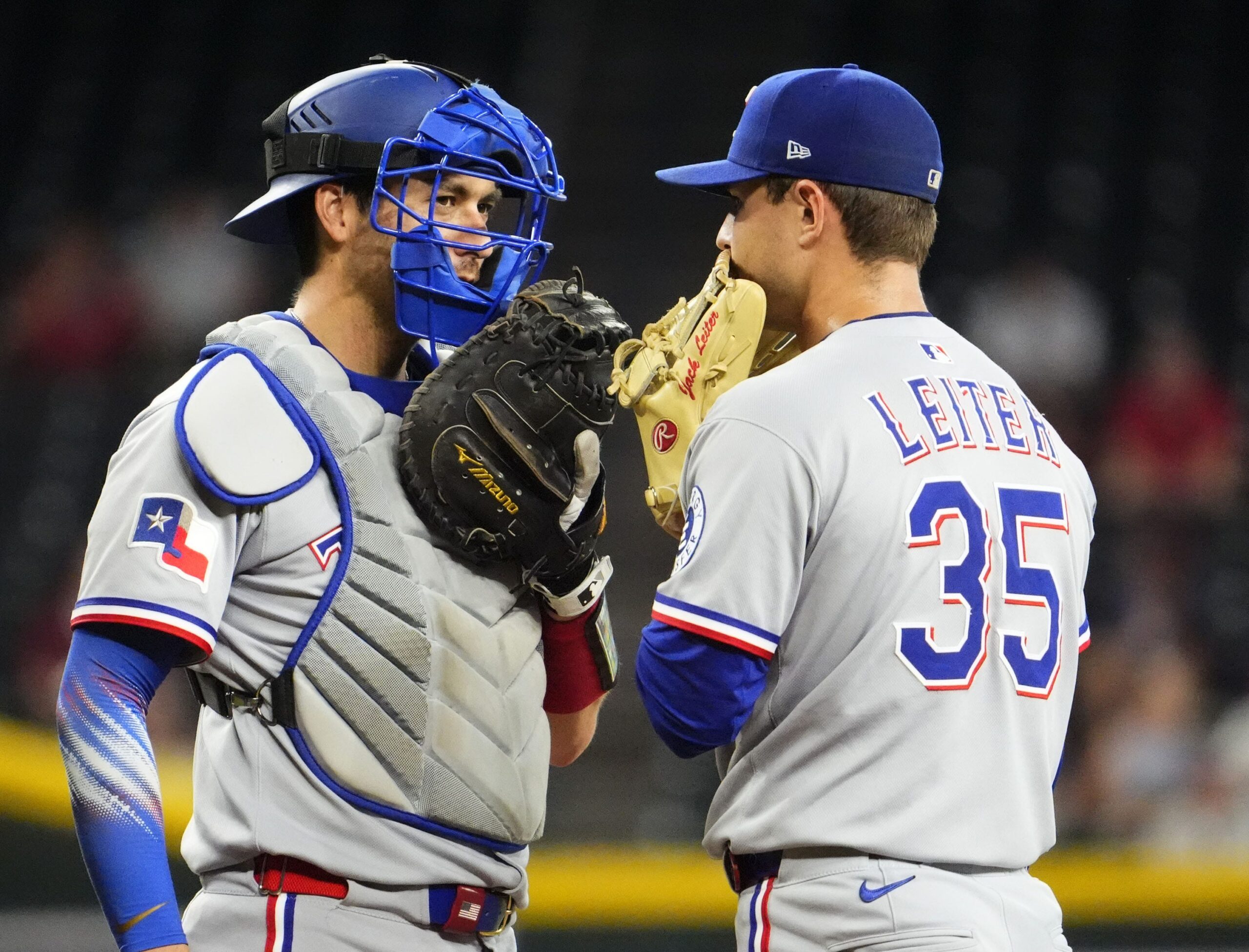 Texas Rangers catcher Kyle Higashioka (11) talks to pitcher Jack Leiter (35) against the Arizona Diamondbacks in the second inning at Chase Field on Sept. 3, 2025.