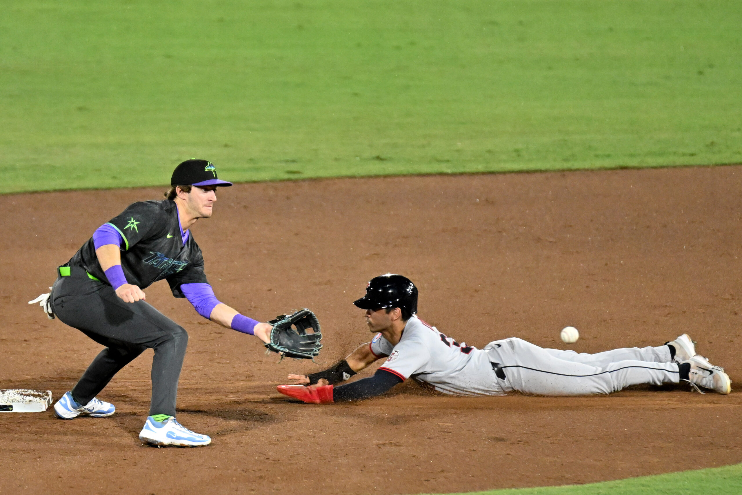 Sep 5, 2025; St. Petersburg, Florida, USA; Tampa Bay Rays shortstop Carson Williams (77) waits for the ball as Cleveland Guardians left fielder Steven Kwan (38) slides into second base for a stolen base in the sixth inning at George M. Steinbrenner Field. Mandatory Credit: Jonathan Dyer-Imagn Images