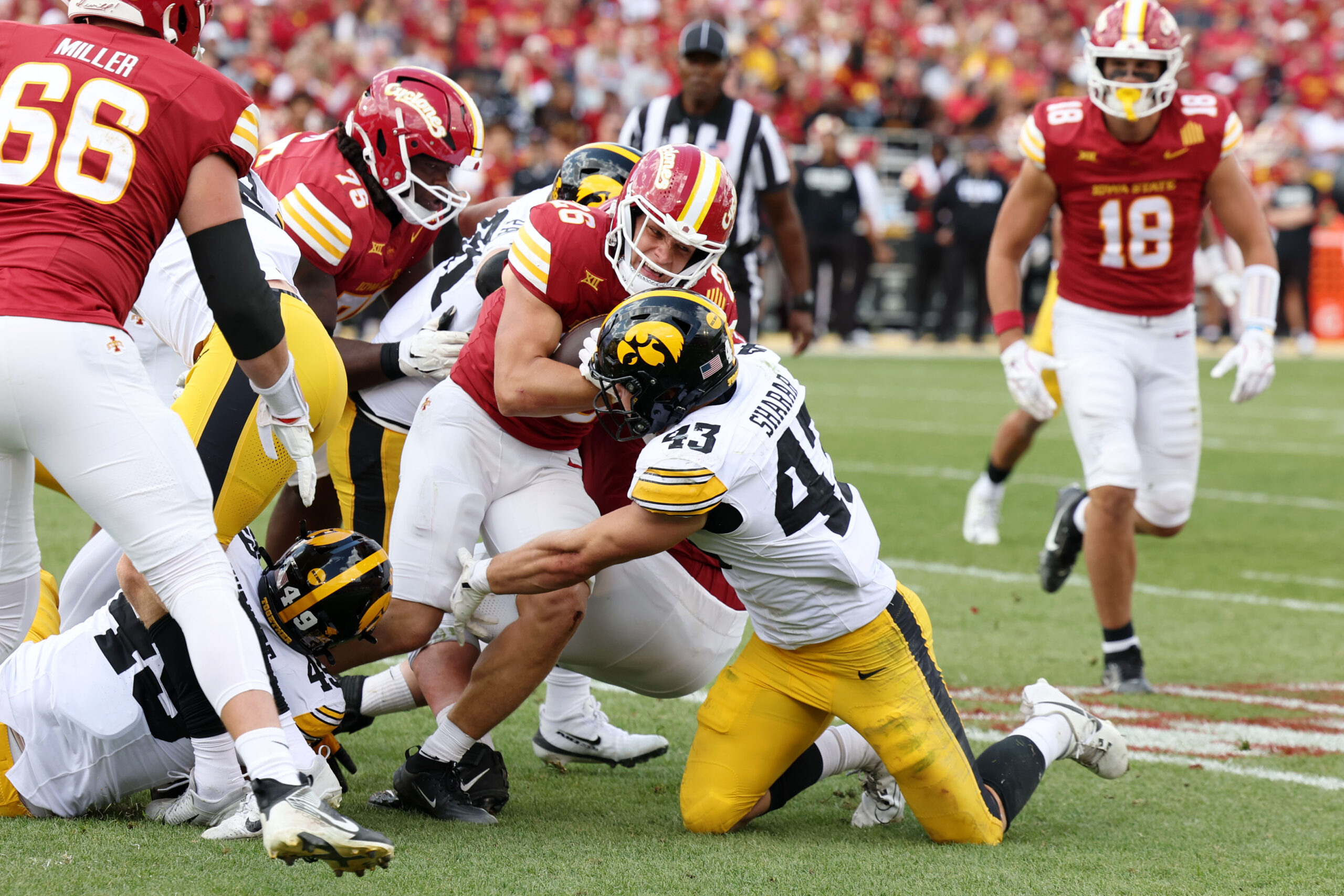 Sep 6, 2025; Ames, Iowa, USA; Iowa Hawkeyes linebacker Karson Sharar (43) tackles Iowa State Cyclones running back Carson Hansen (26) during the second half at Jack Trice Stadium. Mandatory Credit: Reese Strickland-Imagn Images