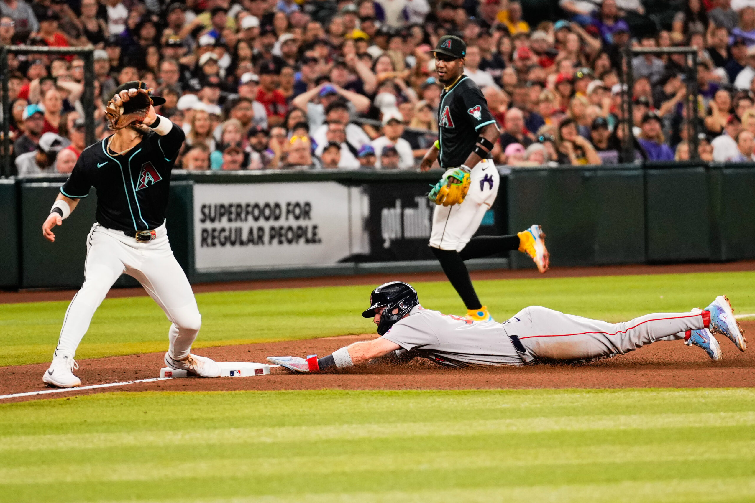 Sep 6, 2025; Phoenix, Arizona, USA; Boston Red Sox first base Romy Gonzalez (23) slides into third during the fourth inning between the Arizona Diamondbacks and the Boston Red Sox at Chase Field. Mandatory Credit: Arianna Grainey-Imagn Images