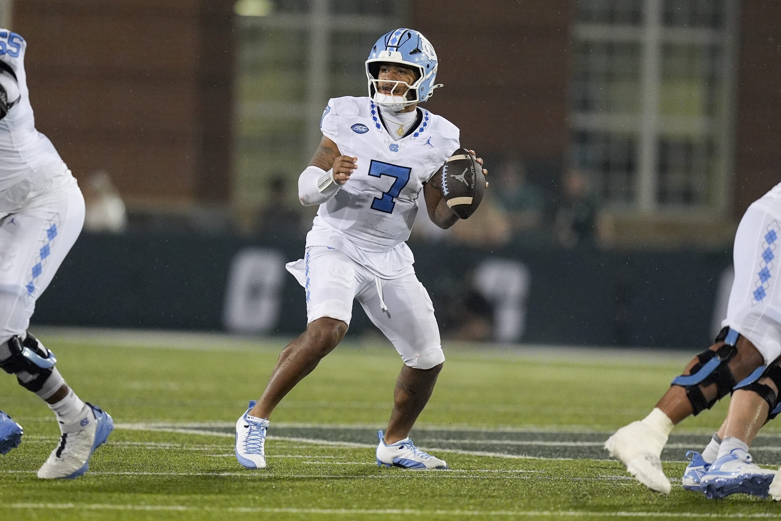 Sep 6, 2025; Charlotte, North Carolina, USA; North Carolina Tar Heels quarterback Gio Lopez (7) looks for a receiver against the Charlotte 49ers during the second half at Jerry Richardson Stadium. Mandatory Credit: Jim Dedmon-Imagn Images