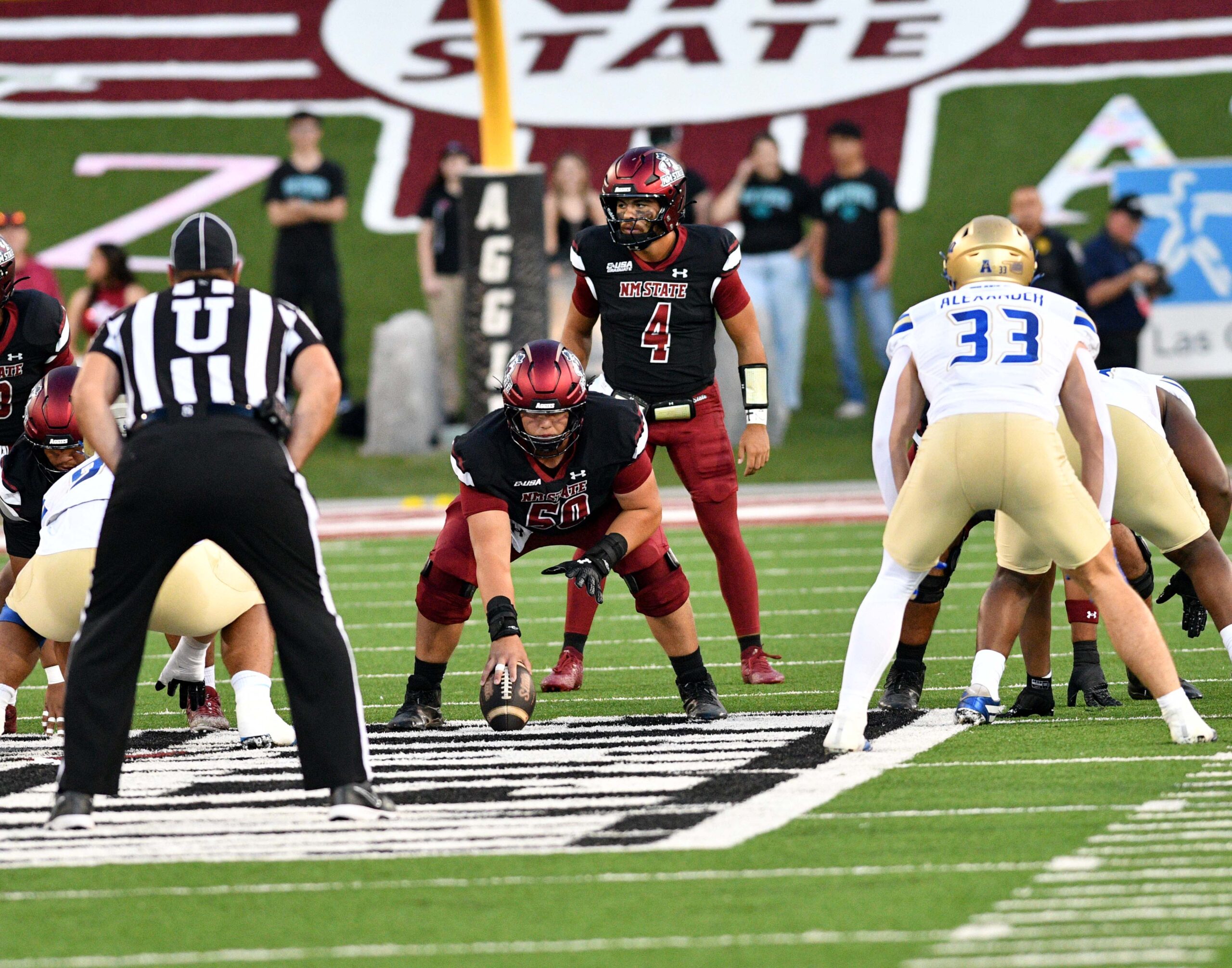 Aggie quarterback Logan Fife (4) looks over the defense as NMSU took on the University of Tulsa Golden Hurricane on Saturday in Las Cruces.