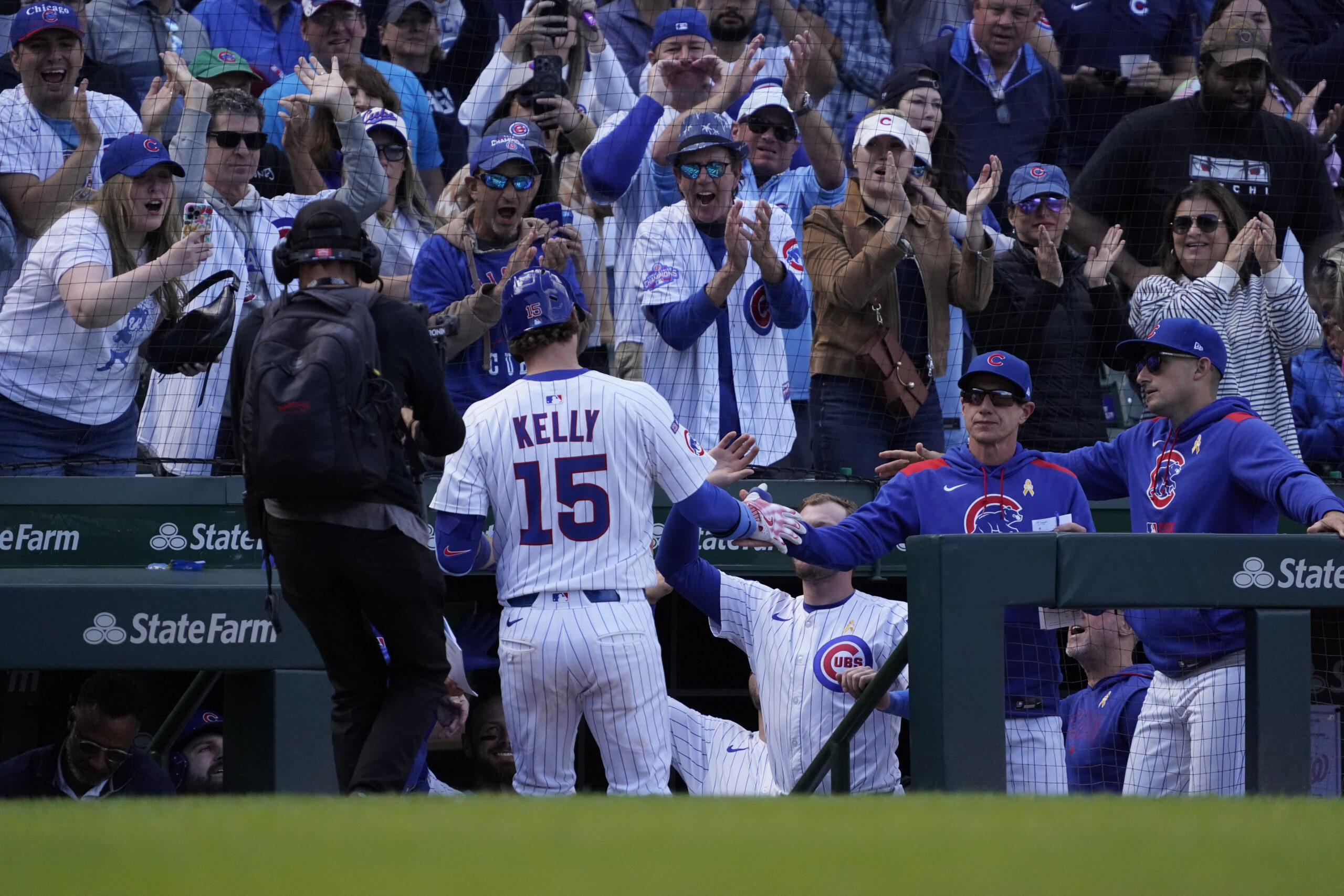 Sep 7, 2025; Chicago, Illinois, USA; Chicago Cubs catcher Carson Kelly (15) is greeted after hitting a home run against the Washington Nationals during the eighth inning at Wrigley Field. Mandatory Credit: David Banks-Imagn Images