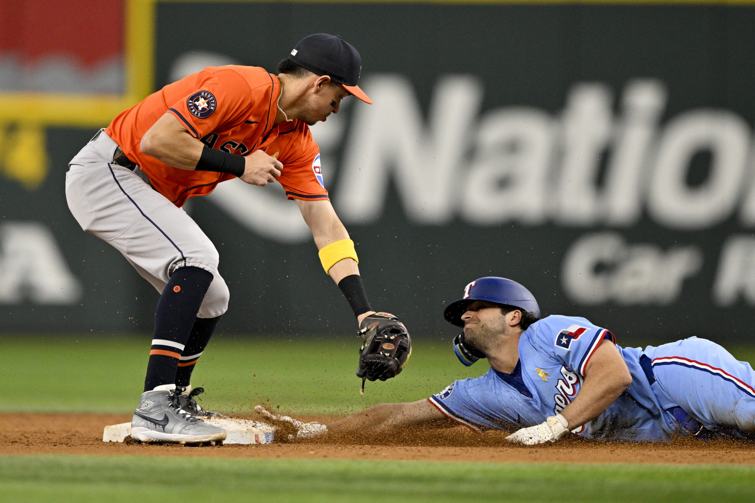 Sep 7, 2025; Arlington, Texas, USA; at Texas Rangers shortstop Josh Smith (8) slides under the tag of Houston Astros second baseman Mauricio Dubon (14) as he steals second base during the eighth inning at Globe Life Field. Mandatory Credit: Jerome Miron-Imagn Images