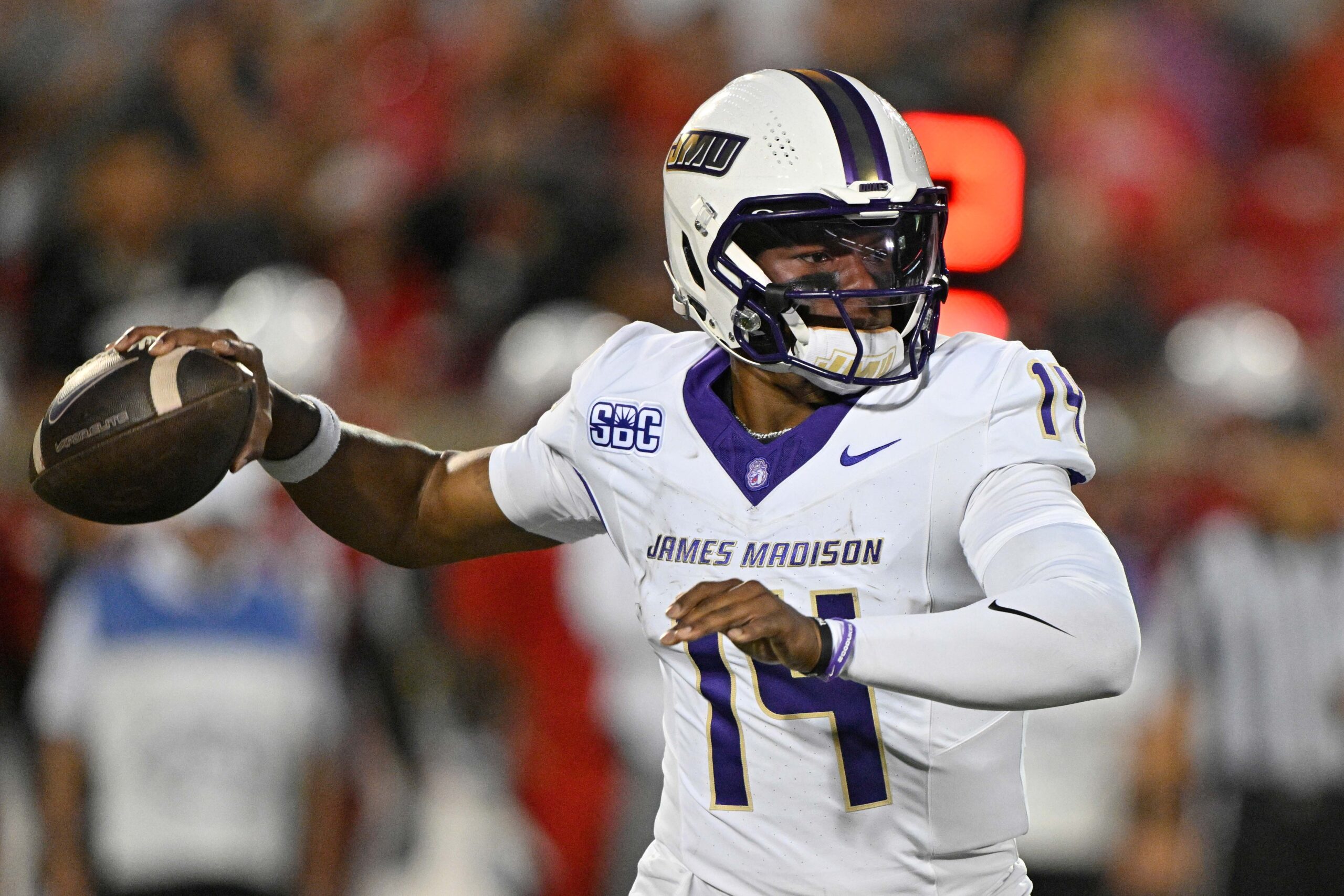 Sep 5, 2025; Louisville, Kentucky, USA; James Madison Dukes quarterback Alonza Barnett III (14) looks to pass against the Louisville Cardinals during the first half at L&N Federal Credit Union Stadium. Louisville defeated James Madison 28-14. Mandatory Credit: Jamie Rhodes-Imagn Images