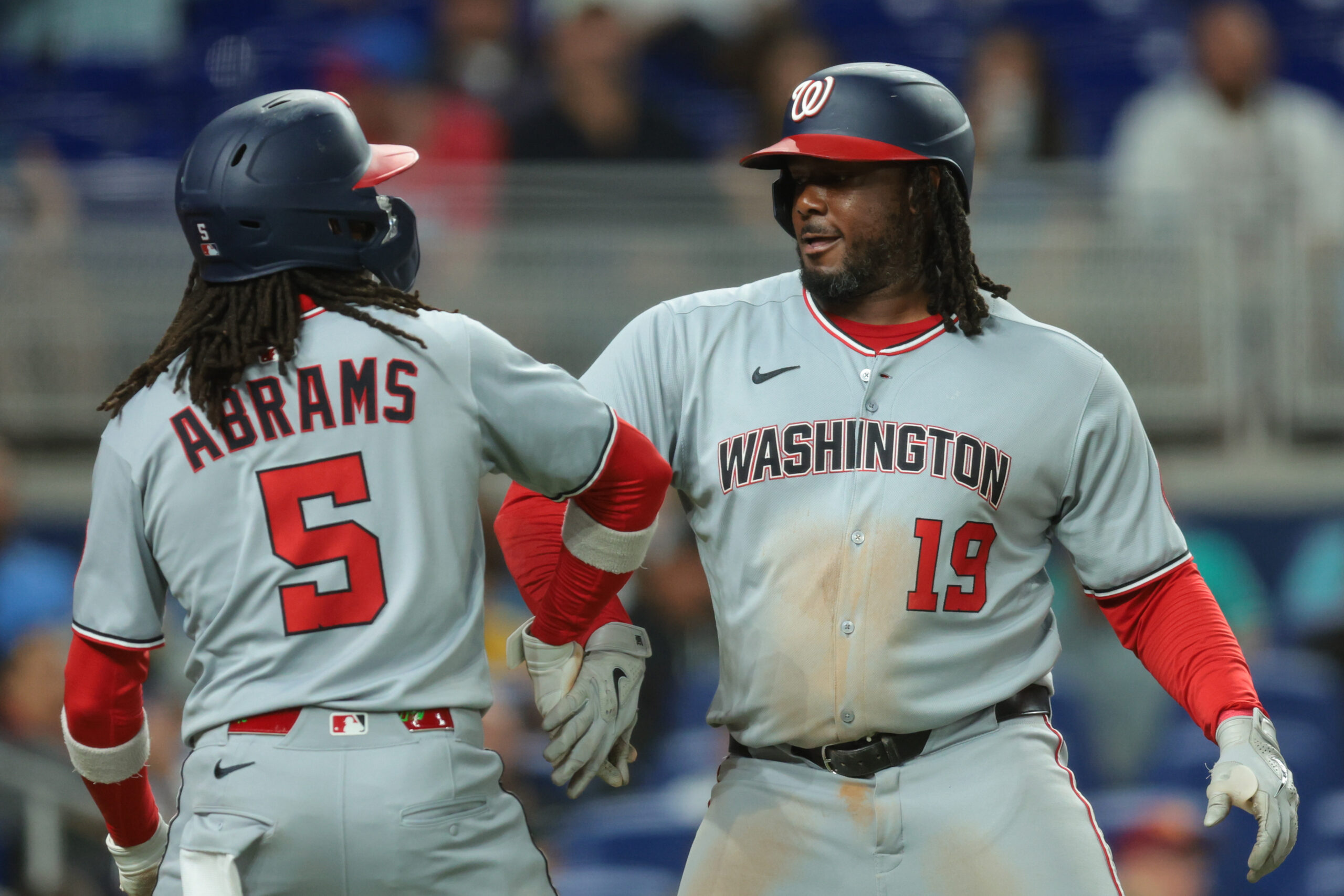 Sep 8, 2025; Miami, Florida, USA; Washington Nationals first baseman Josh Bell (19) celebrates with shortstop CJ Abrams (5) after hitting a two-run home run against the Miami Marlins during the sixth inning at loanDepot Park. Mandatory Credit: Sam Navarro-Imagn Images
