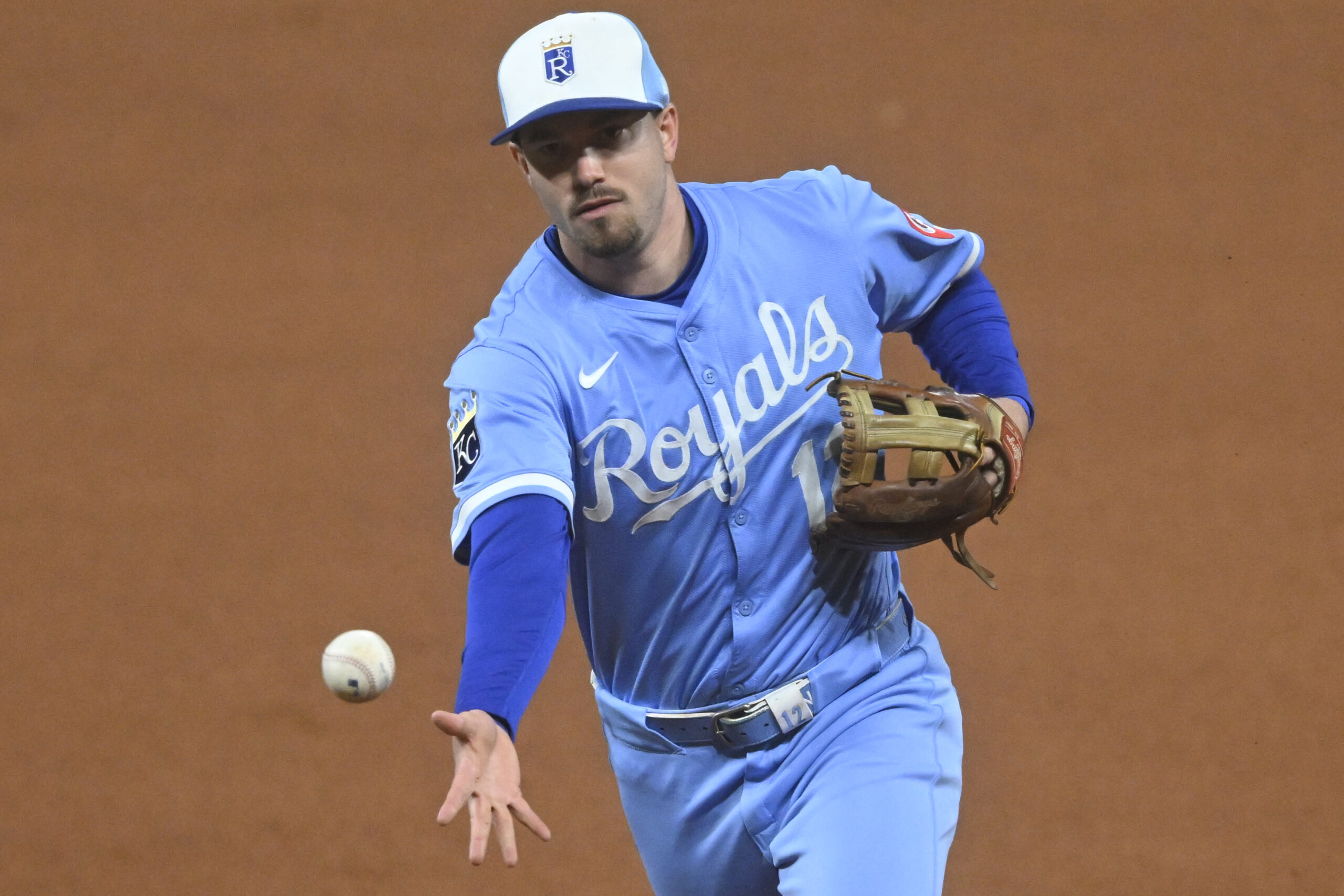 Sep 9, 2025; Cleveland, Ohio, USA; Kansas City Royals second baseman Nick Loftin (12) tosses the ball to first base in the seventh inning against the Cleveland Guardians at Progressive Field. Mandatory Credit: David Richard-Imagn Images