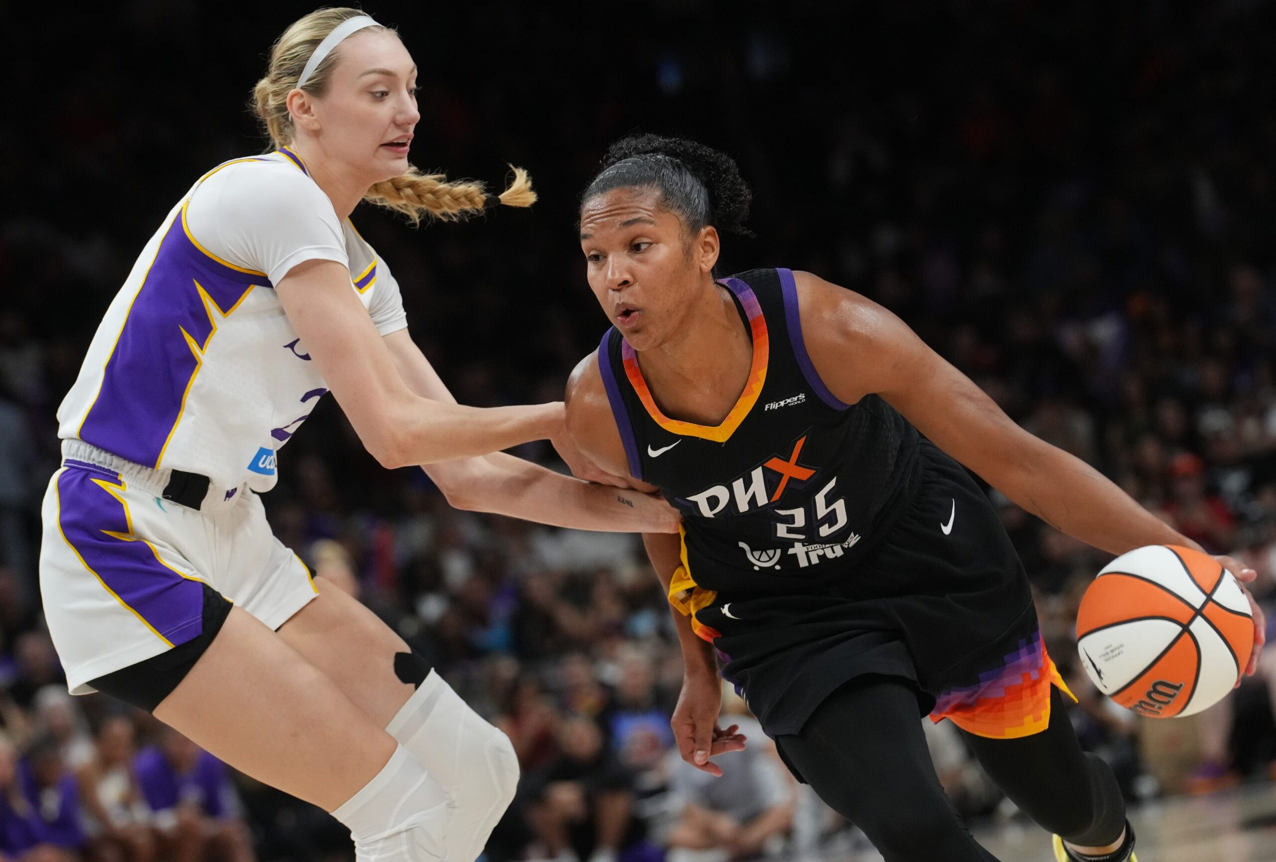 Phoenix Mercury forward Alyssa Thomas (25) drives past Los Angeles Sparks forward Cameron Brink (22) at PHX Arena on Sept. 9, 2025.
