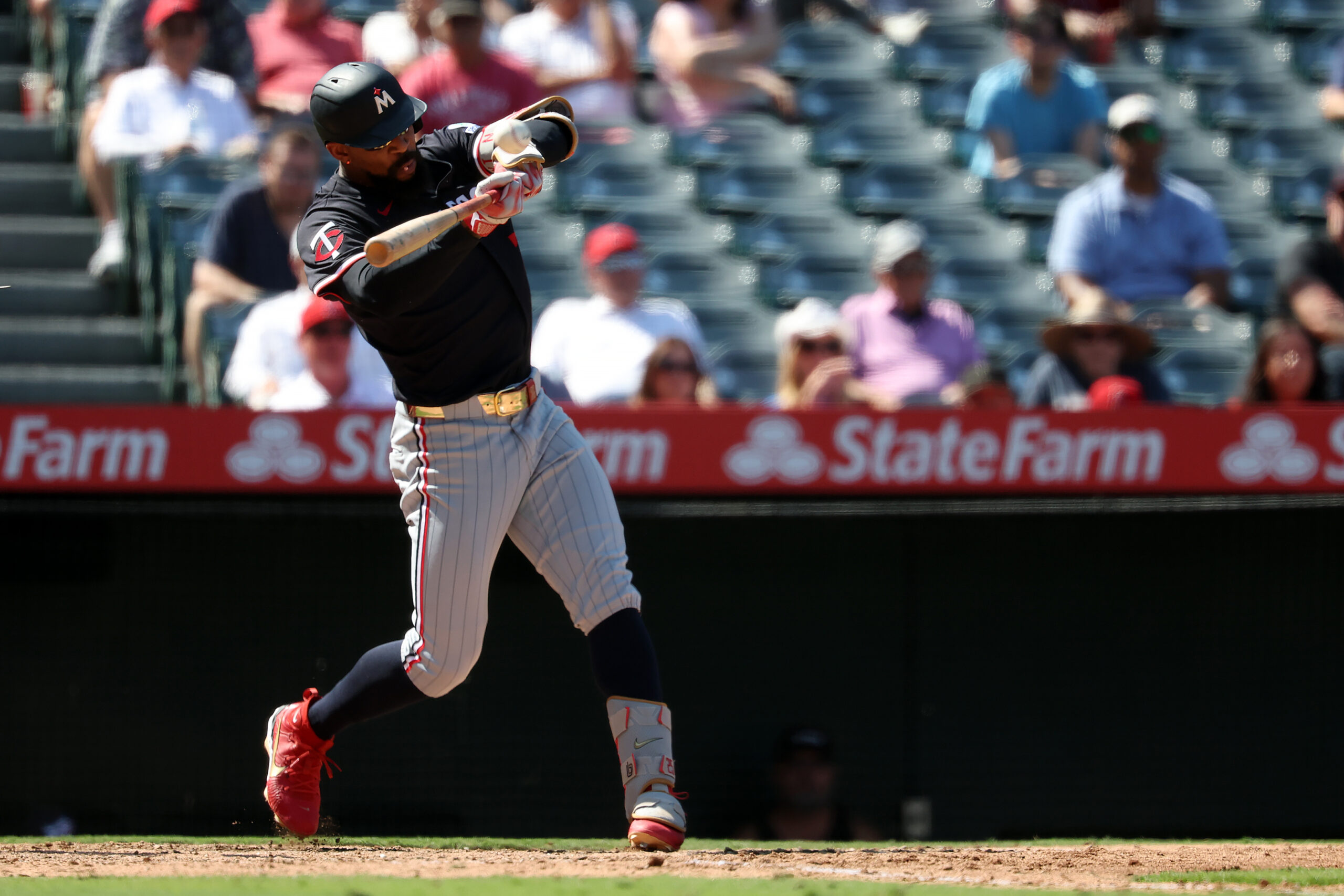 Sep 10, 2025; Anaheim, California, USA;  Minnesota Twins designated hitter Byron Buxton (25) hits a two-run home run during the sixth inning against the Los Angeles Angels at Angel Stadium. Mandatory Credit: Kiyoshi Mio-Imagn Images