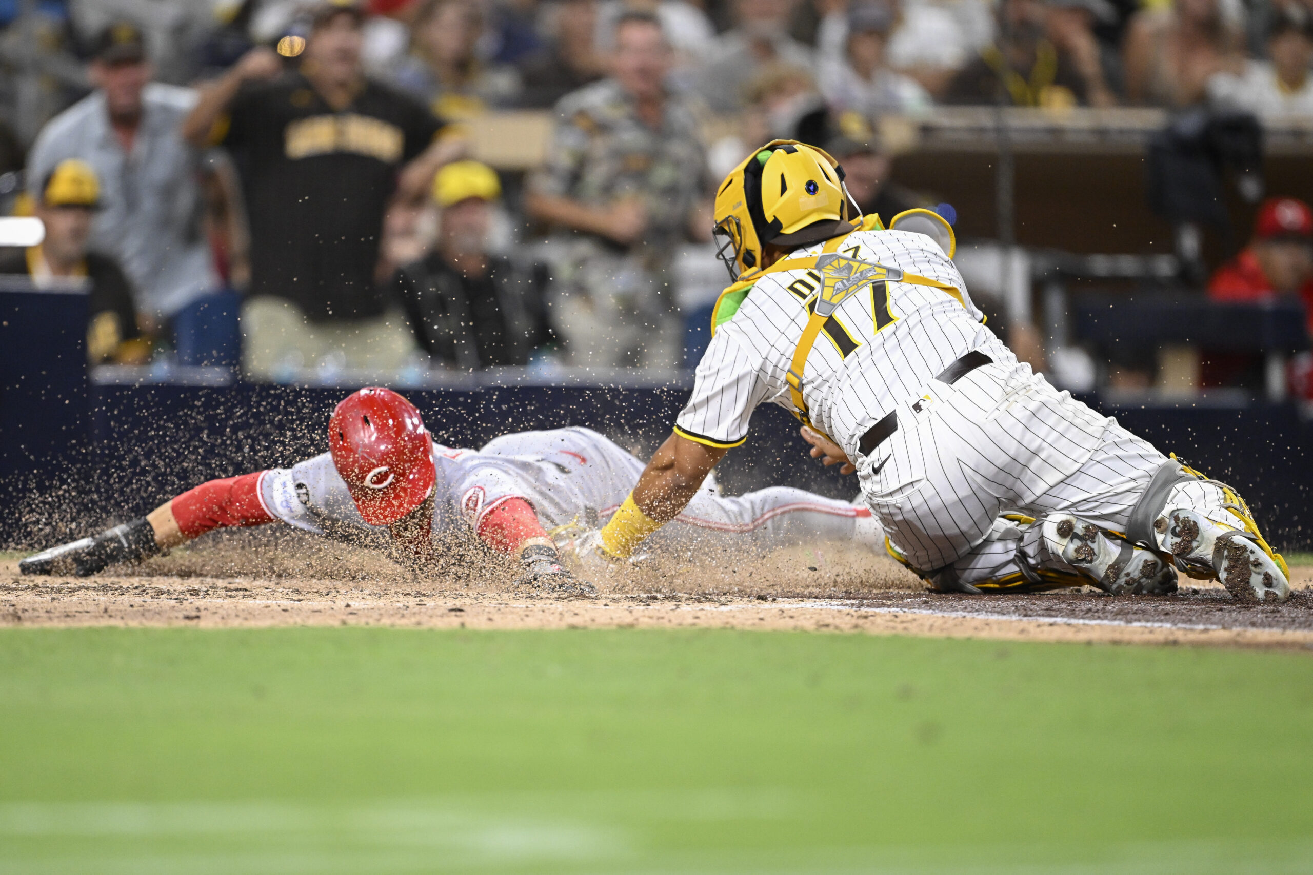 Sep 10, 2025; San Diego, California, USA; Cincinnati Reds center fielder TJ Friedl (29) scores ahead tag of San Diego Padres catcher Elias Diaz (17) during the eighth inning at Petco Park. Mandatory Credit: Denis Poroy-Imagn Images