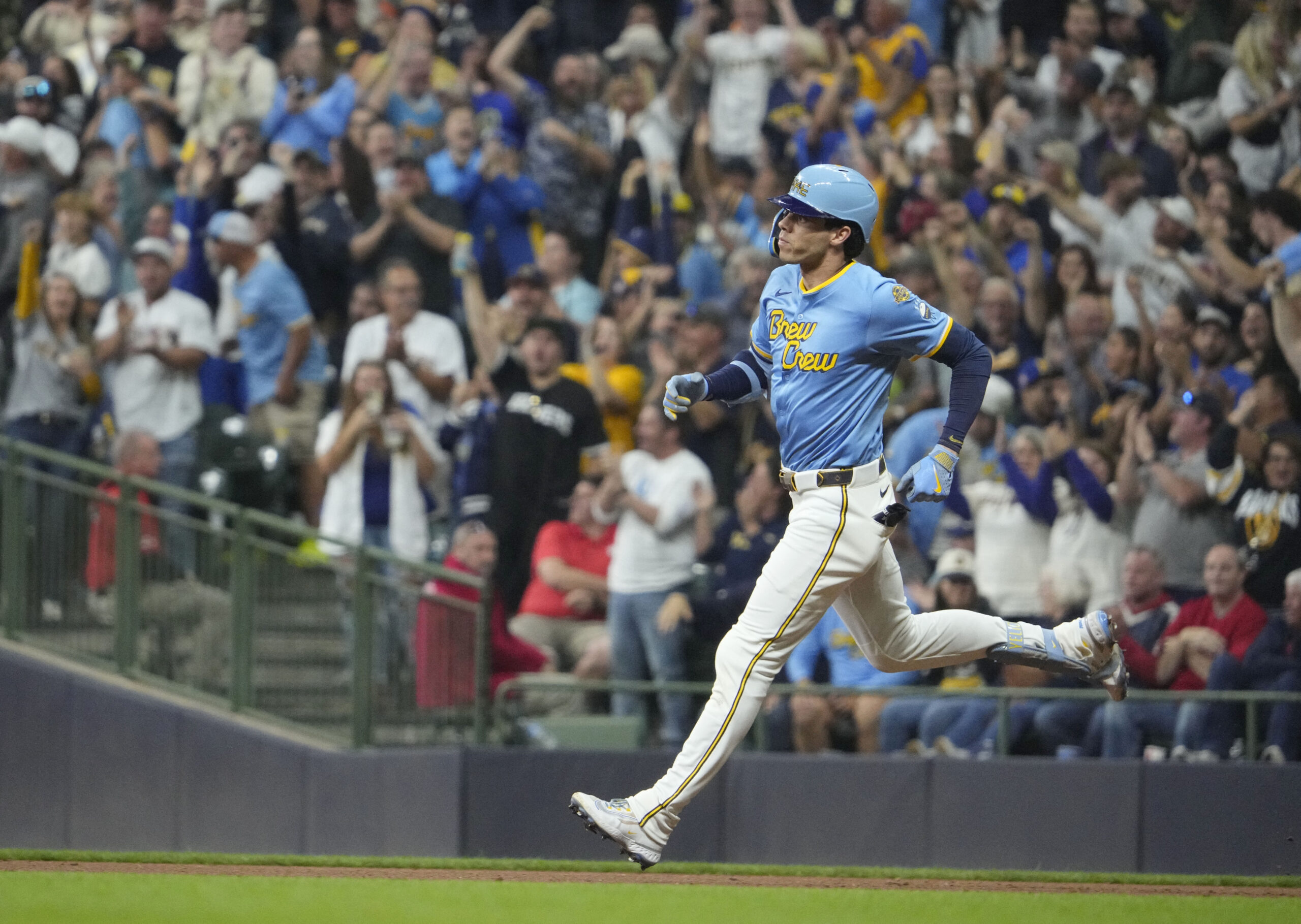 Sep 12, 2025; Milwaukee, Wisconsin, USA; Milwaukee Brewers outfielder Christian Yelich (22) hits a home run against the St. Louis Cardinals in the seventh inning at American Family Field. Mandatory Credit: Michael McLoone-Imagn Images