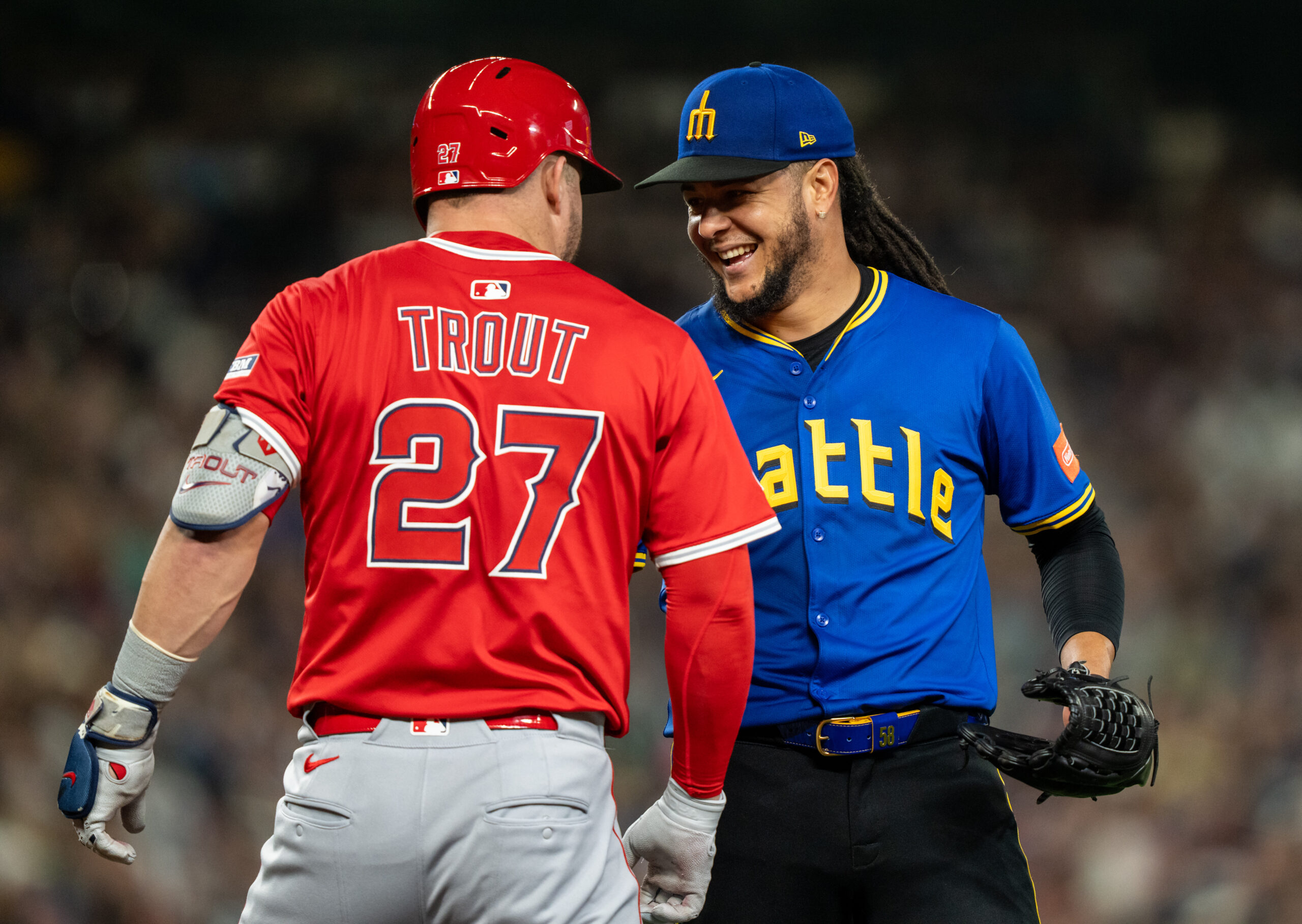 Sep 12, 2025; Seattle, Washington, USA; Seattle Mariners starting pitcher Luis Castillo (58) jokes with Los Angeles Angels designated hitter Mike Trout (27) during the sixth inning at T-Mobile Park. Mandatory Credit: Stephen Brashear-Imagn Images