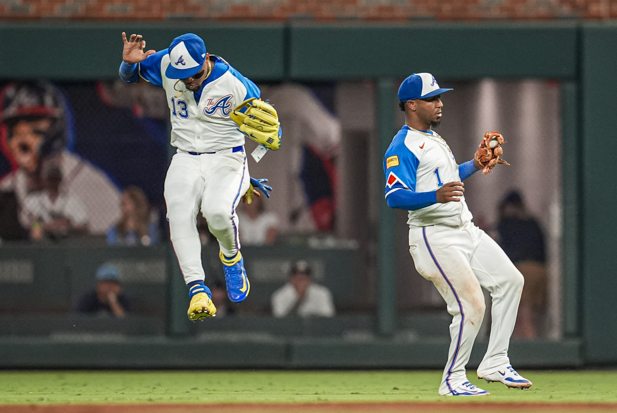 Sep 13, 2025; Cumberland, Georgia, USA; Atlanta Braves right fielder Ronald Acuna Jr (13) and second baseman Ozzie Albies (1) avoid a collision after Albies catches a pop up against the Houston Astros during the ninth inning at Truist Park. Mandatory Credit: Dale Zanine-Imagn Images