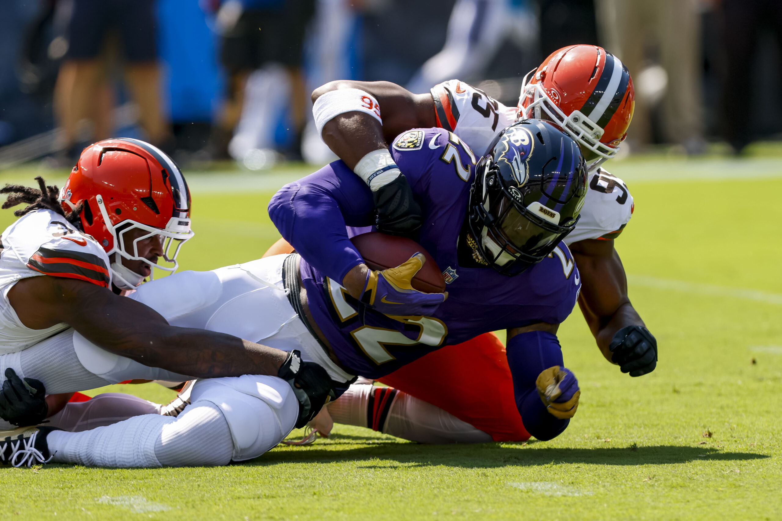 Sep 14, 2025; Baltimore, Maryland, USA; Baltimore Ravens running back Derrick Henry (22) is tackled by Cleveland Browns defensive end Myles Garrett (95) during the first quarter at M&T Bank Stadium. Mandatory Credit: Peter Casey-Imagn Images