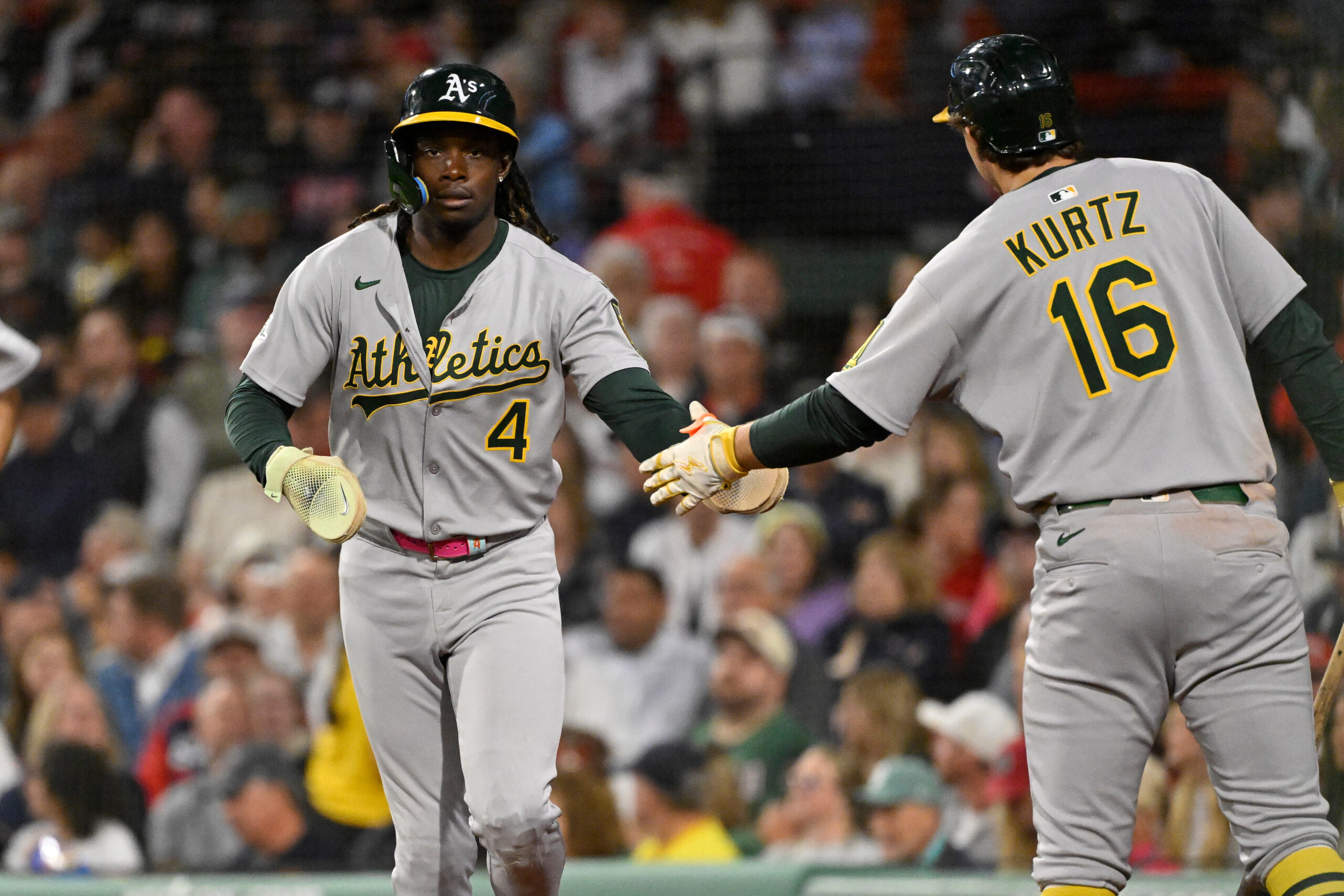 Sep 17, 2025; Boston, Massachusetts, USA; Athletics center fielder Lawrence Butler (4) celebrates scoring a run against the Boston Red Sox with first baseman Nick Kurtz (16) during the second inning at Fenway Park. Mandatory Credit: Eric Canha-Imagn Images