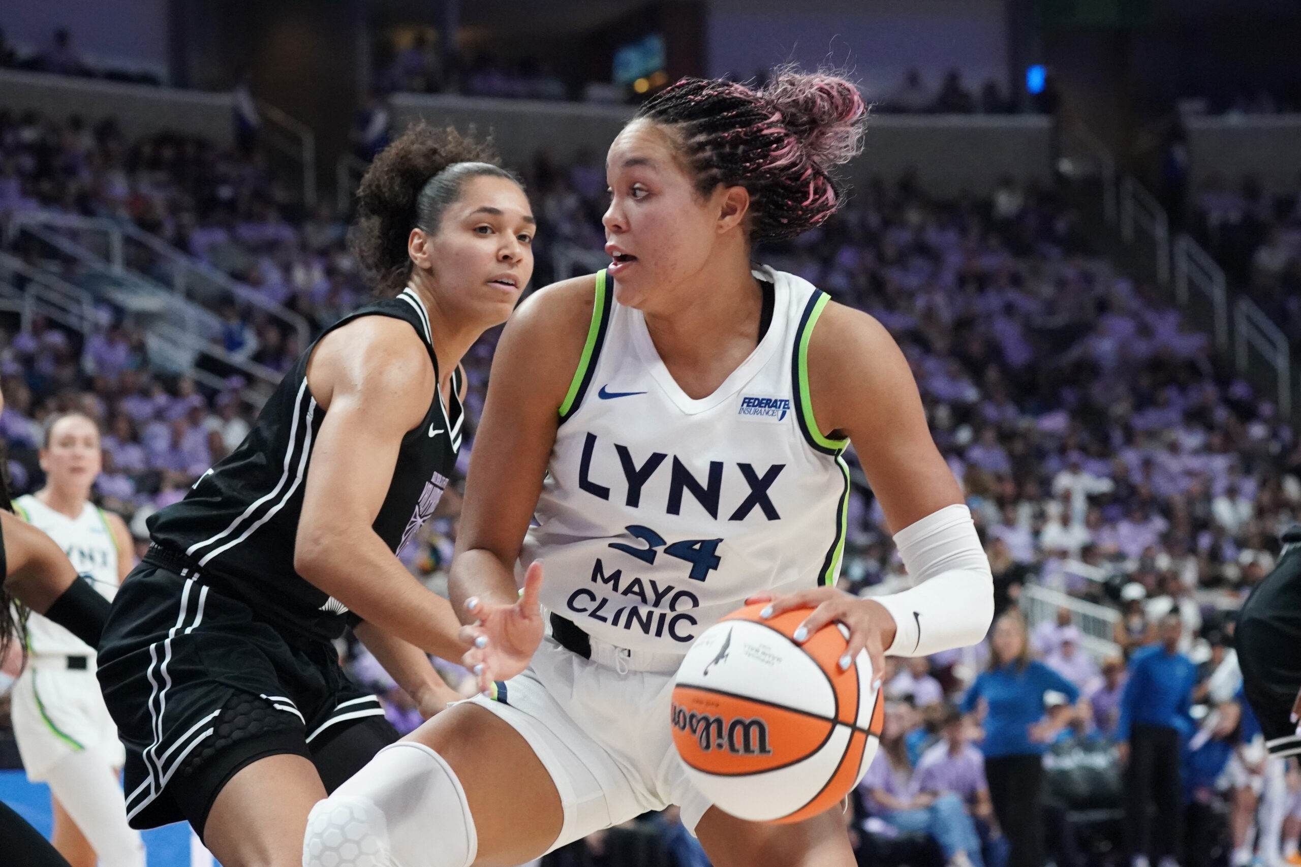 Sep 17, 2025; San Jose, California, USA; Minnesota Lynx forward Napheesa Collier (24) dribbles against Golden State Valkyries forward Janelle Salaun (13) in the third quarter in game two of round one for the 2025 WNBA Playoffs at SAP Center. Mandatory Credit: David Gonzales-Imagn Images