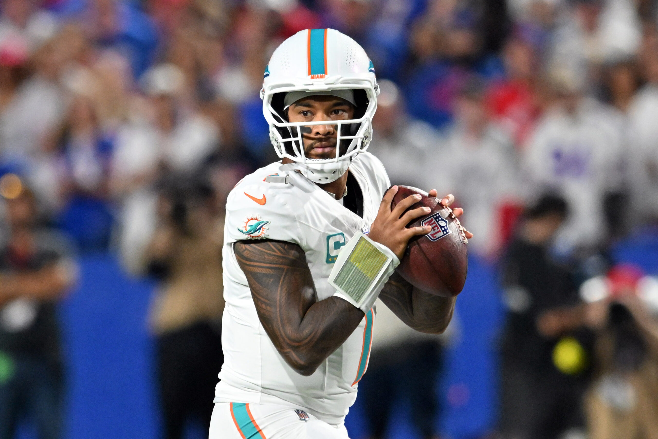 Sep 18, 2025; Orchard Park, New York, USA; Miami Dolphins quarterback Tua Tagovailoa (1) looks to pass in the first half against the Buffalo Bills at Highmark Stadium. Mandatory Credit: Mark Konezny-Imagn Images