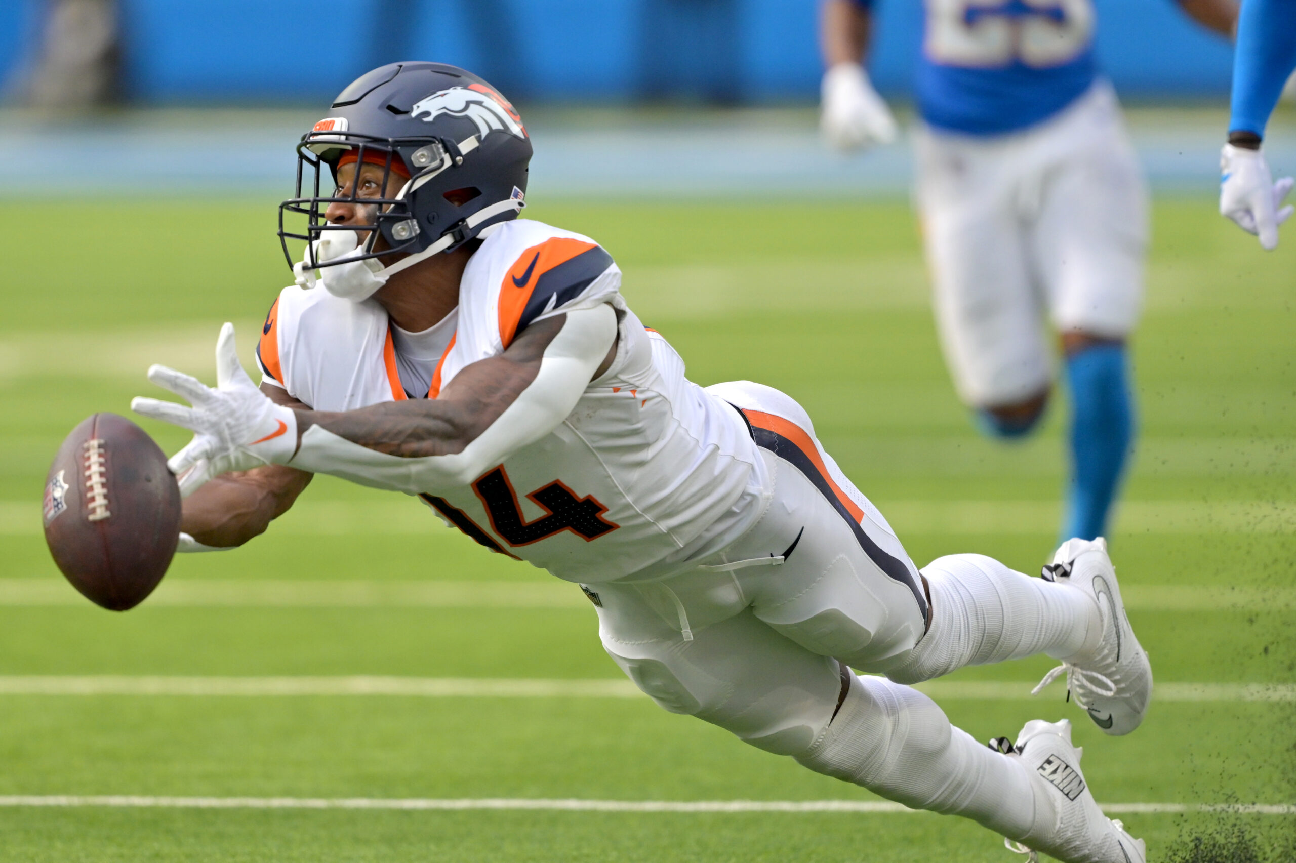 Sep 21, 2025; Inglewood, California, USA;  Denver Broncos wide receiver Courtland Sutton (14) reaches for a long pass 4th down in the second half against the Los Angeles Chargers at SoFi Stadium. Mandatory Credit: Jayne Kamin-Oncea-Imagn Images
