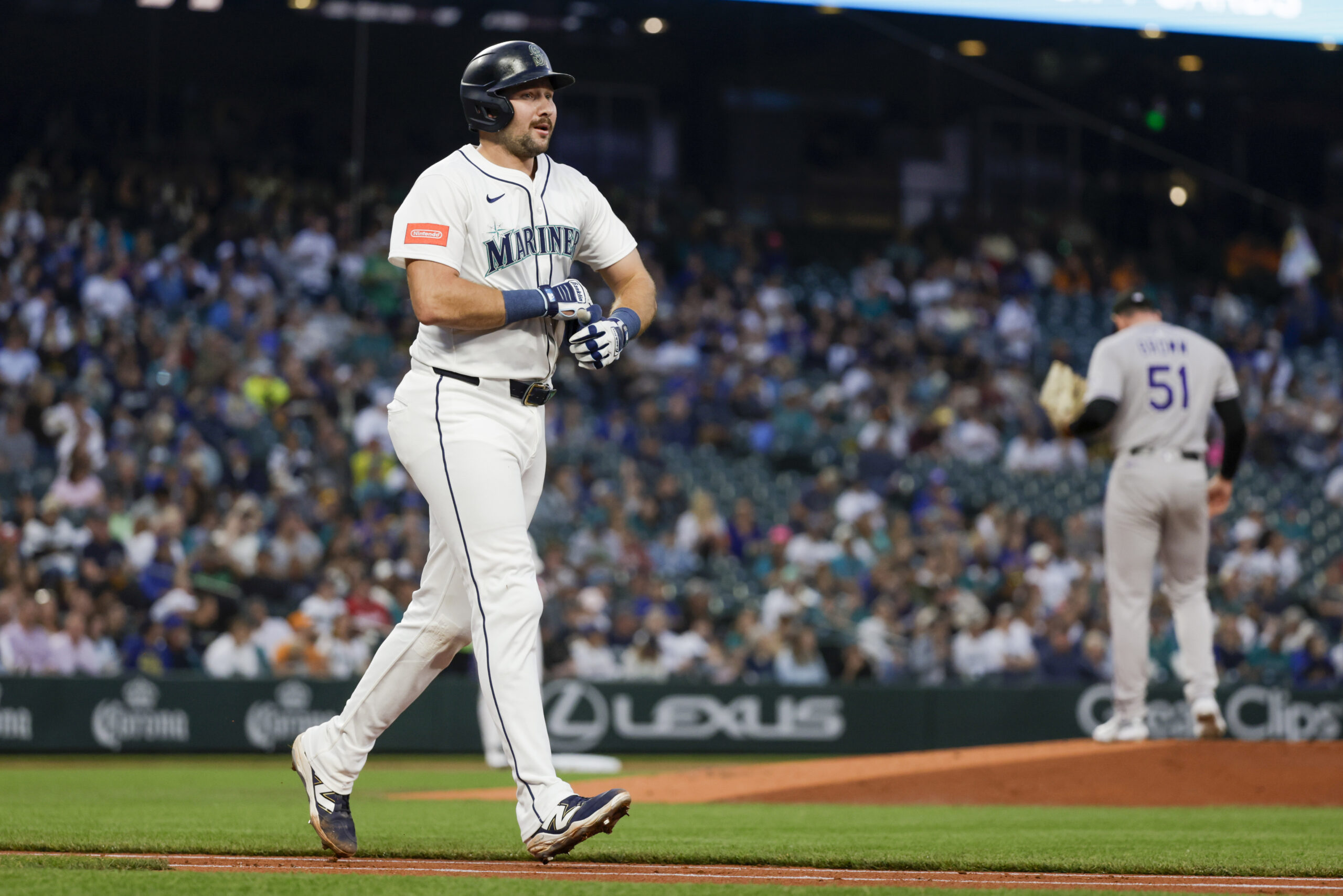 Sep 23, 2025; Seattle, Washington, USA; Seattle Mariners catcher Cal Raleigh (29) advances to first base after being struck by a pitch against the Colorado Rockies during the first inning at T-Mobile Park. Mandatory Credit: Joe Nicholson-Imagn Images