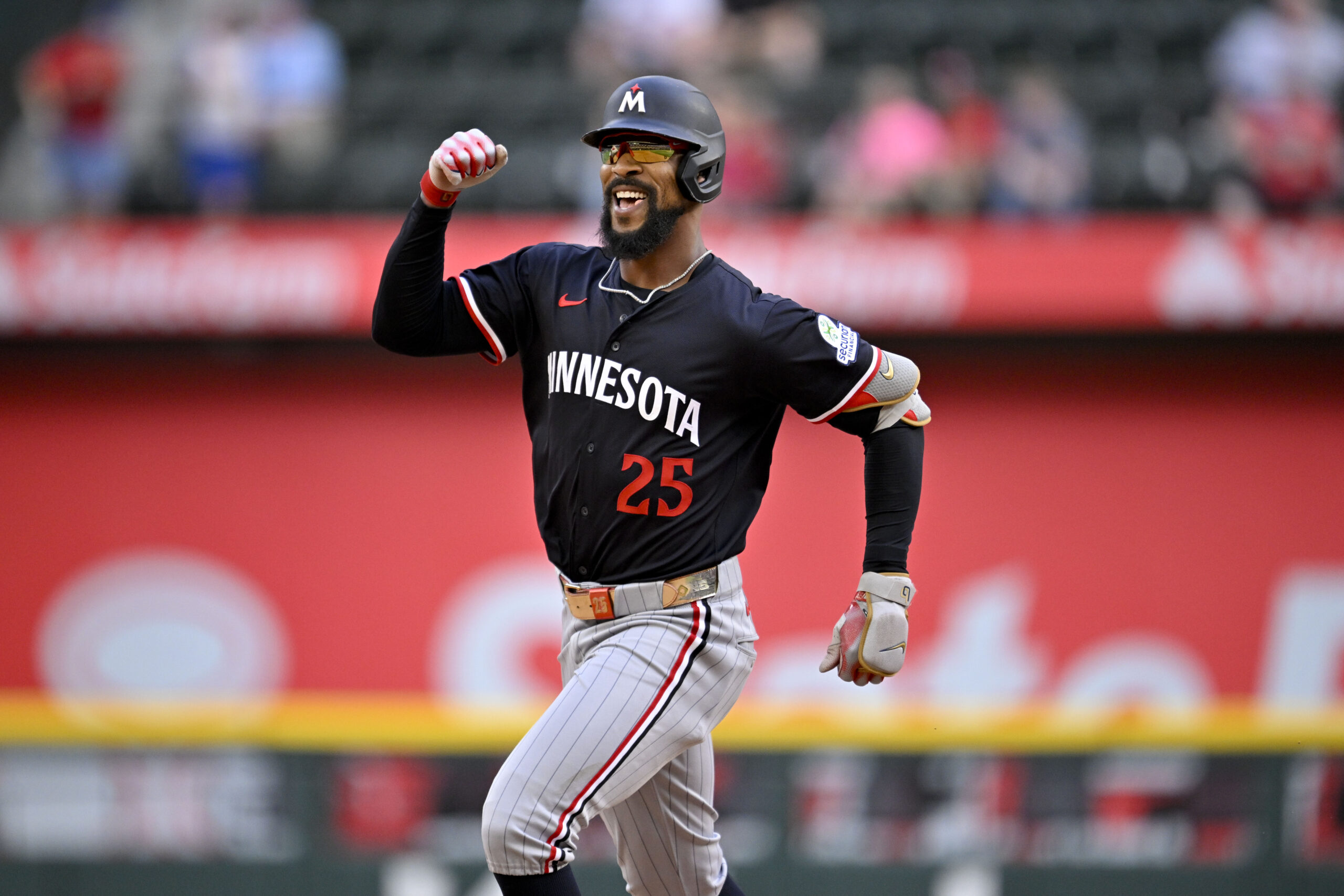 Sep 25, 2025; Arlington, Texas, USA; Minnesota Twins center fielder Byron Buxton (25) celebrates as he rounds the bases after hitting a three run home run against the Texas Rangers during the eighth inning at Globe Life Field. Mandatory Credit: Jerome Miron-Imagn Images