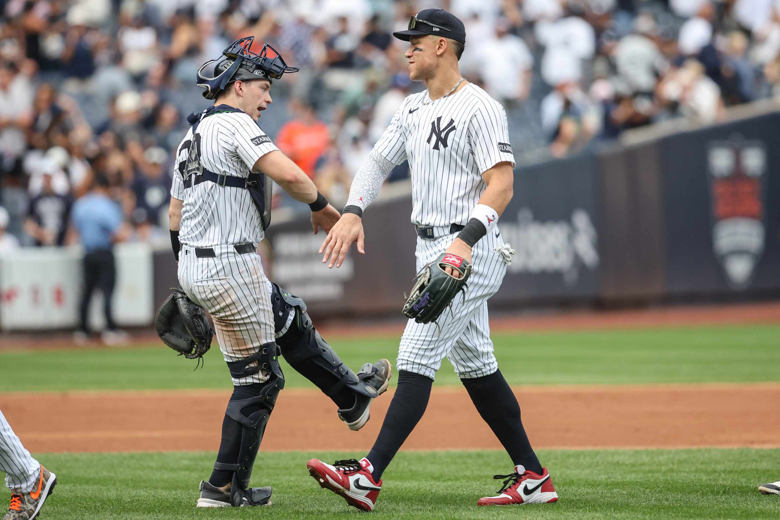 Sep 27, 2025; Bronx, New York, USA;  New York Yankees catcher Ben Rice (22) and right fielder Aaron Judge (99) celebrate after defeating the Baltimore Orioles 6-1 at Yankee Stadium. Mandatory Credit: Wendell Cruz-Imagn Images