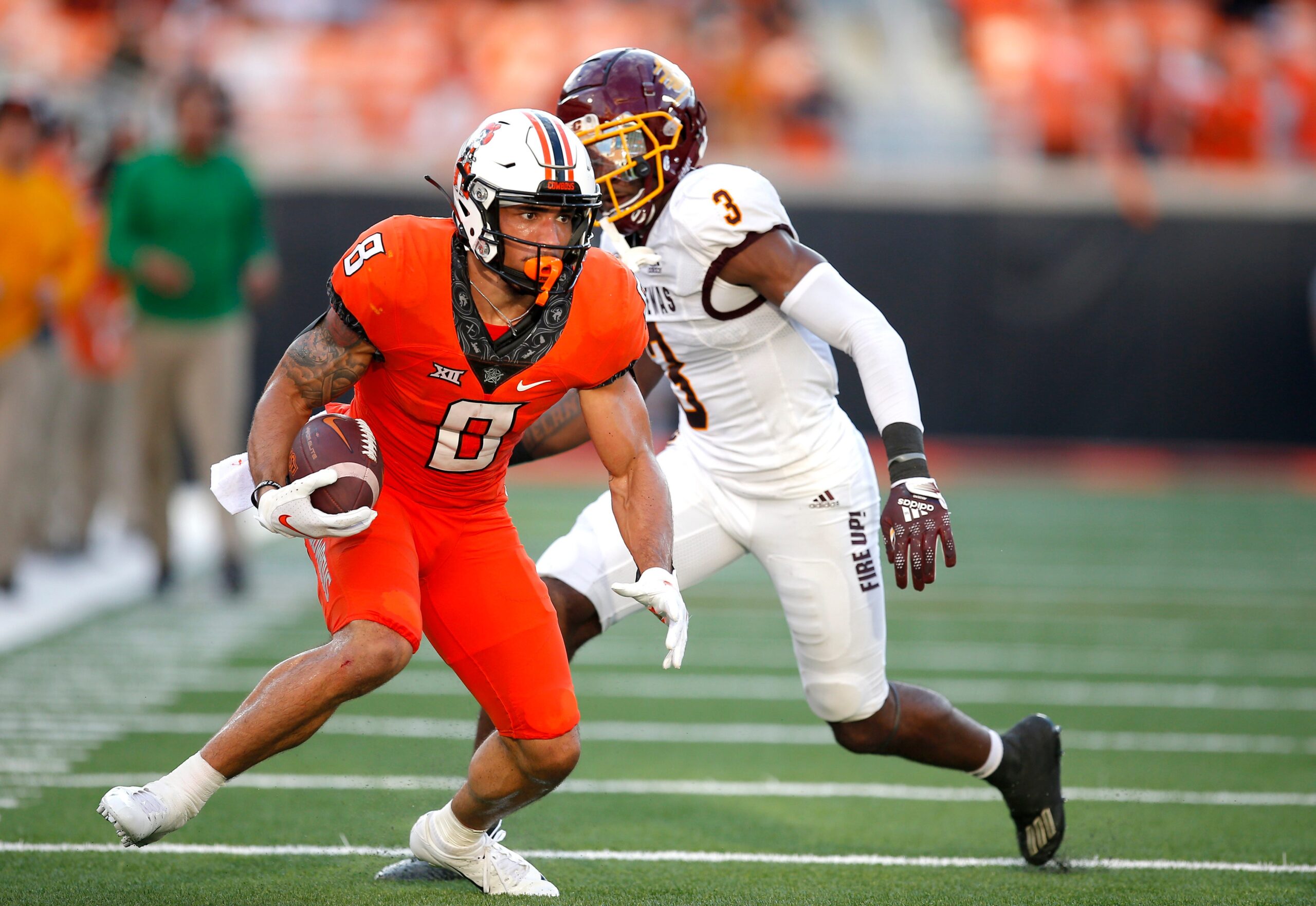 Oklahoma State's Ollie Gordon (0) rushes after a reception as Central Michigan's Trey Jones (3) defends in the second quarter during the college football game between the Oklahoma State Cowboys and Central Michigan Chippewa at Boone Pickens Stadium in Stillwater, Oka., Thursday, Sept., 1, 2022. OSU won 58-44.
Osu Vs Central Michigan