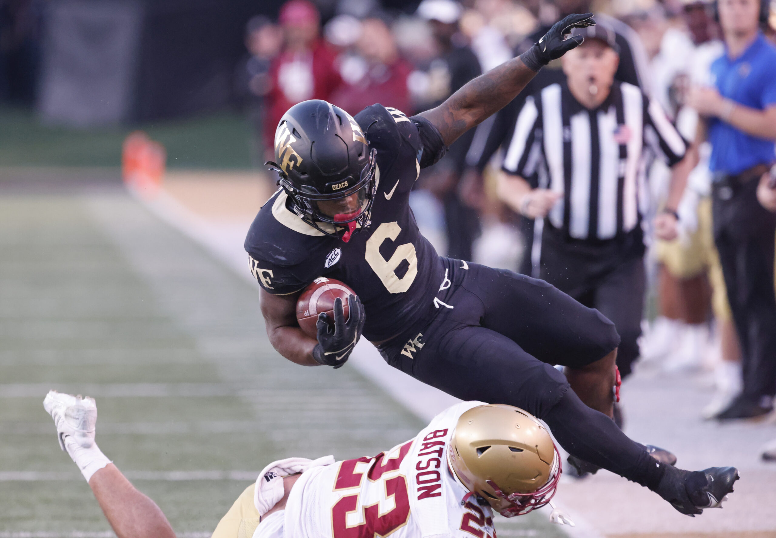Oct 22, 2022; Winston-Salem, North Carolina, USA;  Wake Forest Demon Deacons running back Justice Ellison (6) is brought down by Boston College Eagles defensive back Cole Batson (23) during the second half at Truist Field. Mandatory Credit: Reinhold Matay-Imagn Images