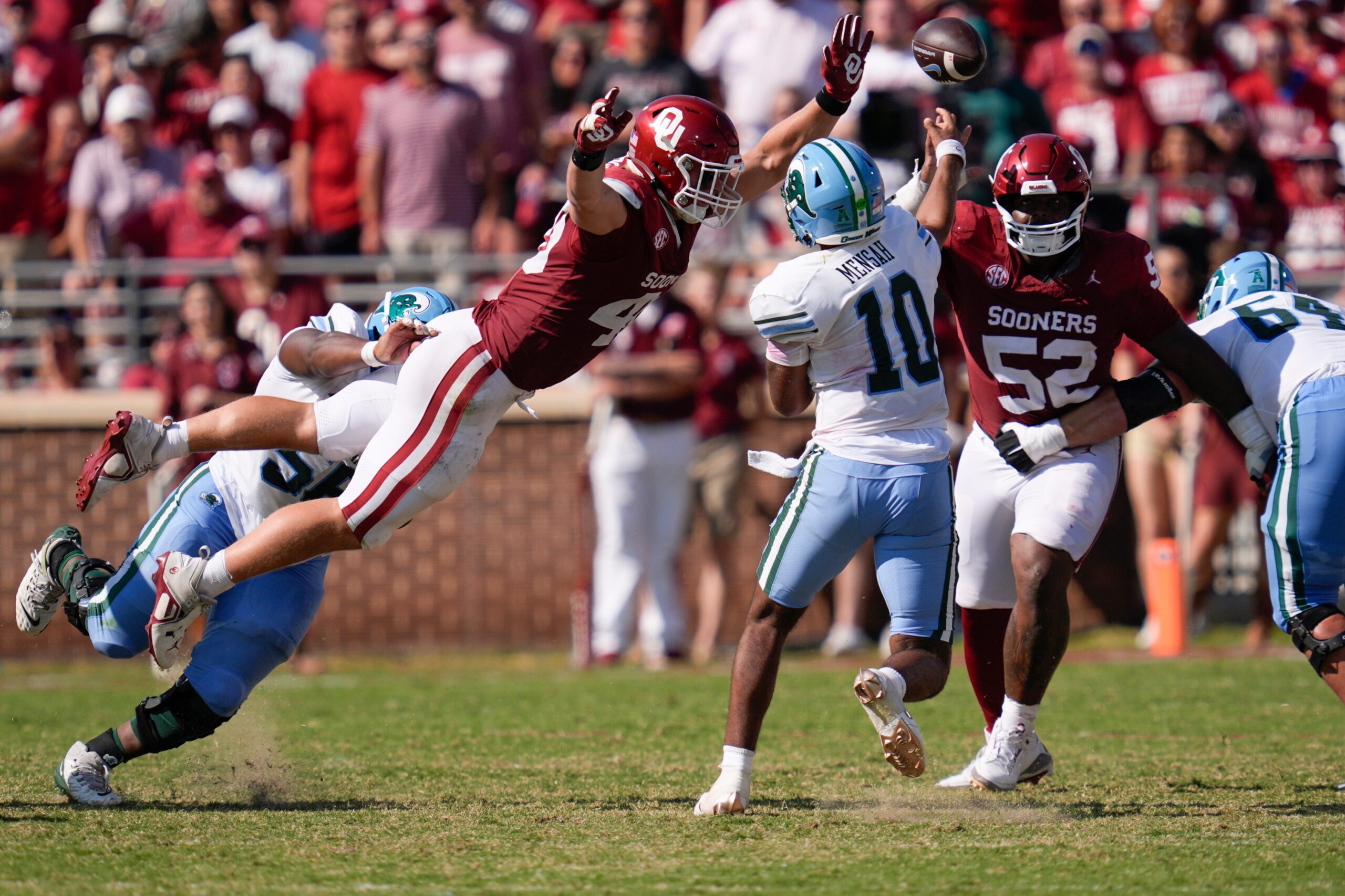 Oklahoma Sooners defensive lineman Ethan Downs (40) leaps at Tulane Green Wave quarterback Darian Mensah (10) beside defensive lineman Damonic Williams (52) during a college football game between the University of Oklahoma Sooners (OU) and the Tulane Green Wave at Gaylord Family - Oklahoma Memorial Stadium in Norman, Okla., Saturday, Sept. 14, 2024.