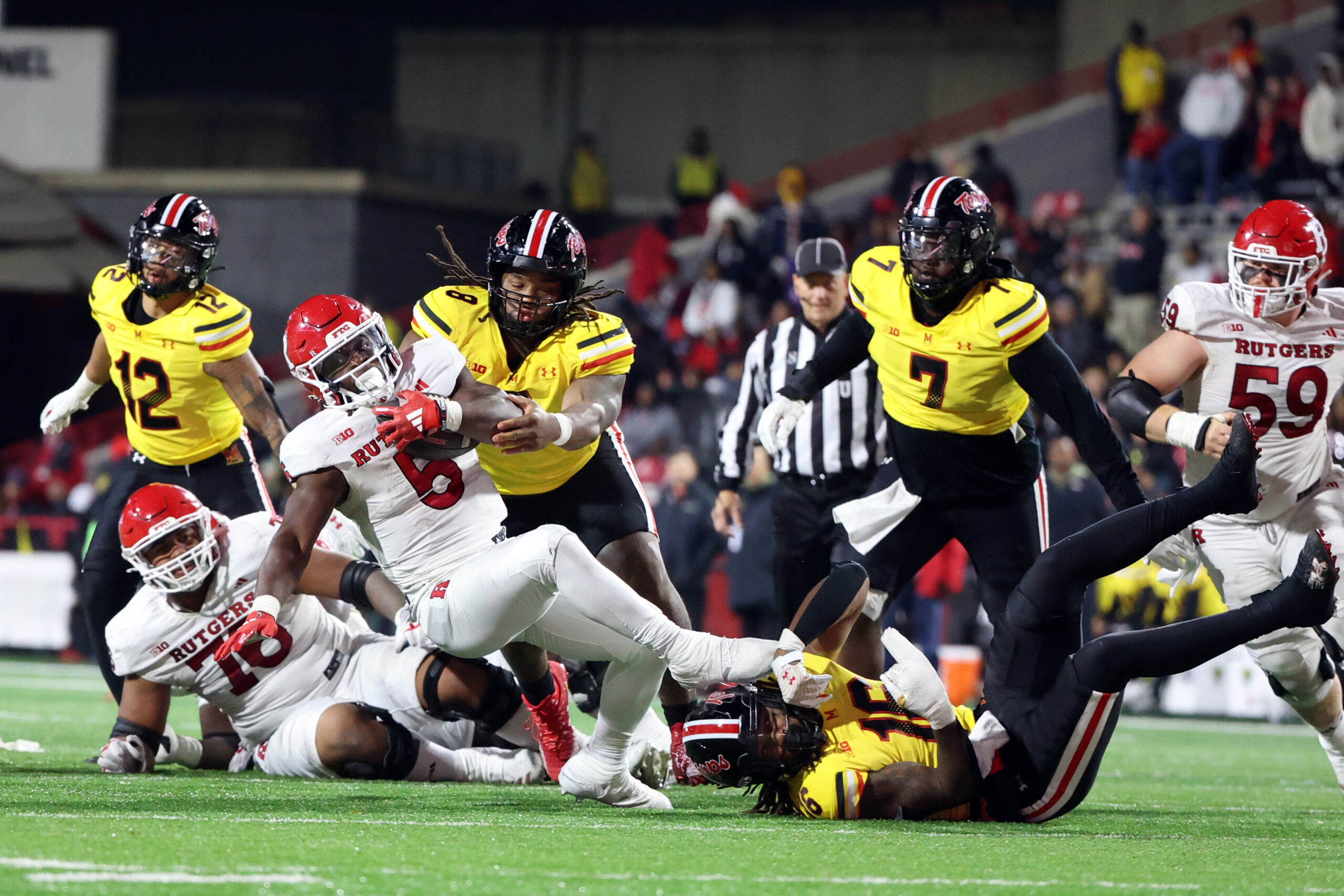 Nov 16, 2024; College Park, Maryland, USA; Maryland Terrapins defensive lineman Jordan Phillips (8) and linebacker Daniel Wingate (16) tackle Rutgers Scarlet Knights wide receiver KJ Duff (8) during the second half at SECU Stadium. Mandatory Credit: Daniel Kucin Jr.-Imagn Images