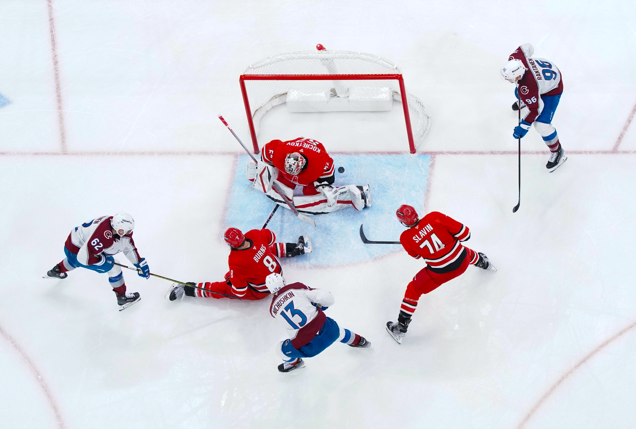 Dec 5, 2024; Raleigh, North Carolina, USA;  Colorado Avalanche right wing Valeri Nichushkin (13) scores a goal past Carolina Hurricanes goaltender Pyotr Kochetkov (52)  defenseman Brent Burns (8) and defenseman Jaccob Slavin (74) during the third period at Lenovo Center. Mandatory Credit: James Guillory-Imagn Images