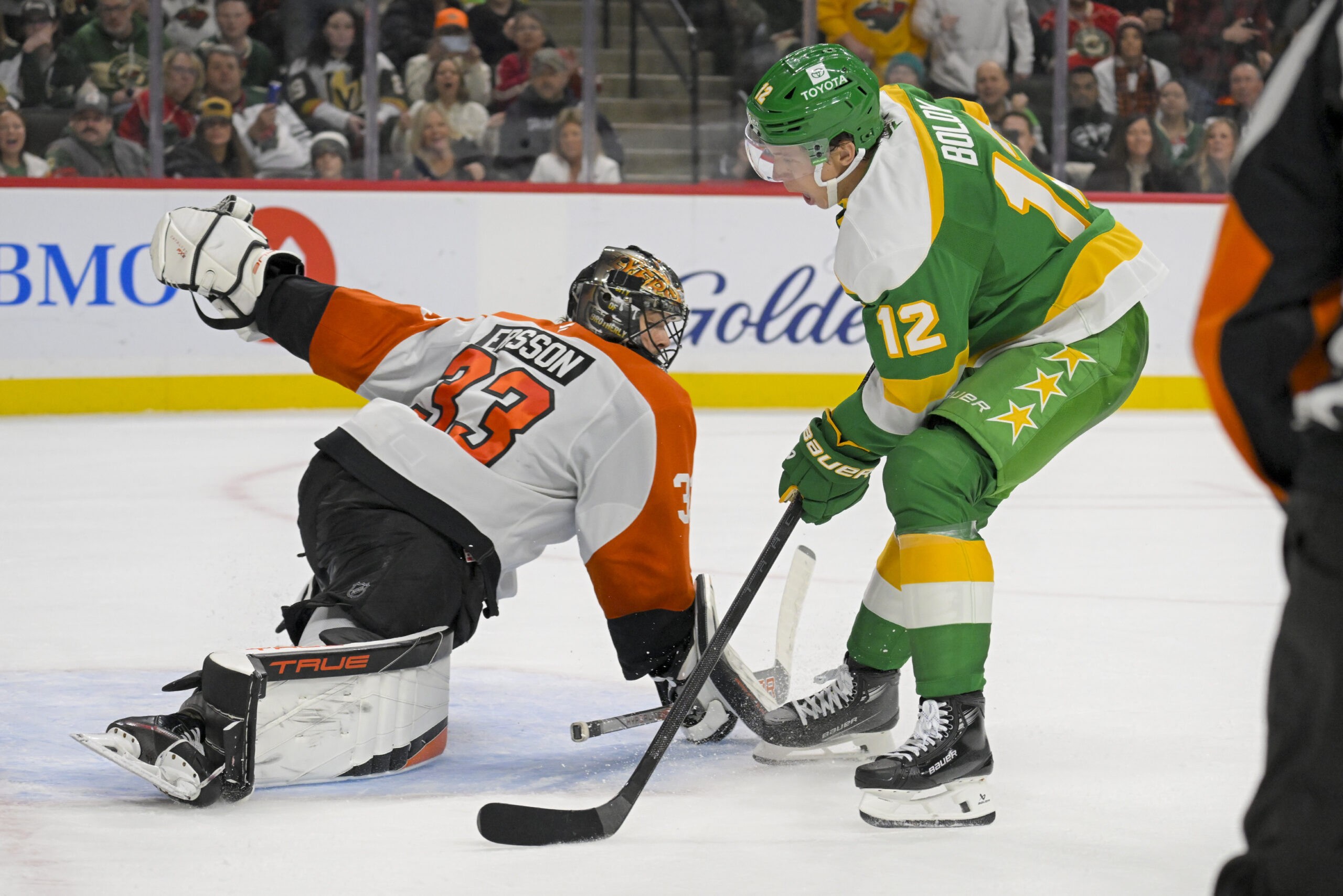 Dec 14, 2024; Saint Paul, Minnesota, USA;  Minnesota Wild forward Matt Boldy (12) scores a breakaway goal against  Philadelphia Flyers goalie Samuel Ersson (33) during the second period at Xcel Energy Center. Mandatory Credit: Nick Wosika-Imagn Images