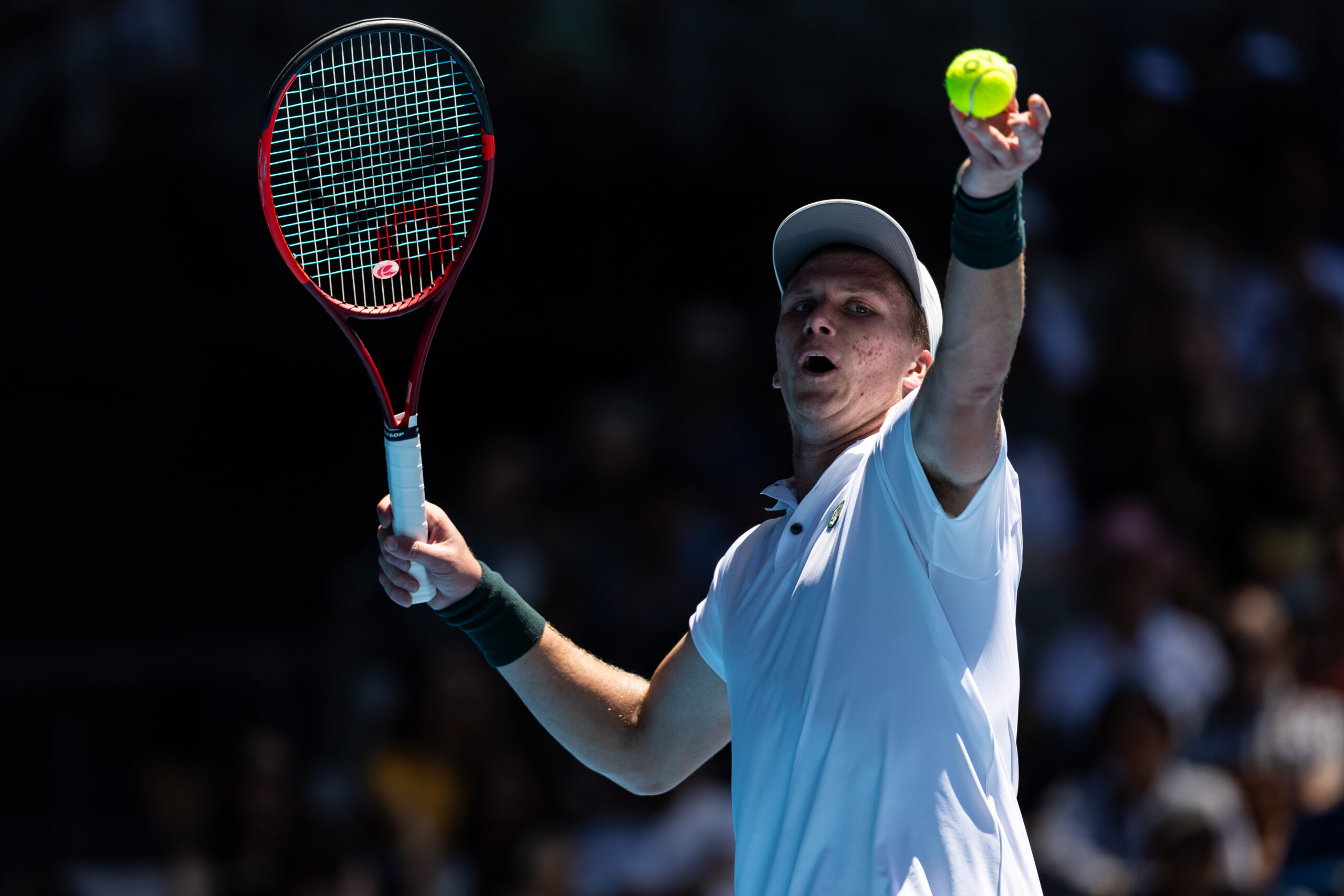 Jan 14, 2025; Melbourne, Victoria, Australia; Jenson Brooksby of United States of America serves during his match against Taylor Fritz of United States of America in the first round of the men's singles at the 2025 Australian Open at Melbourne Park. Mandatory Credit: Mike Frey-Imagn Images