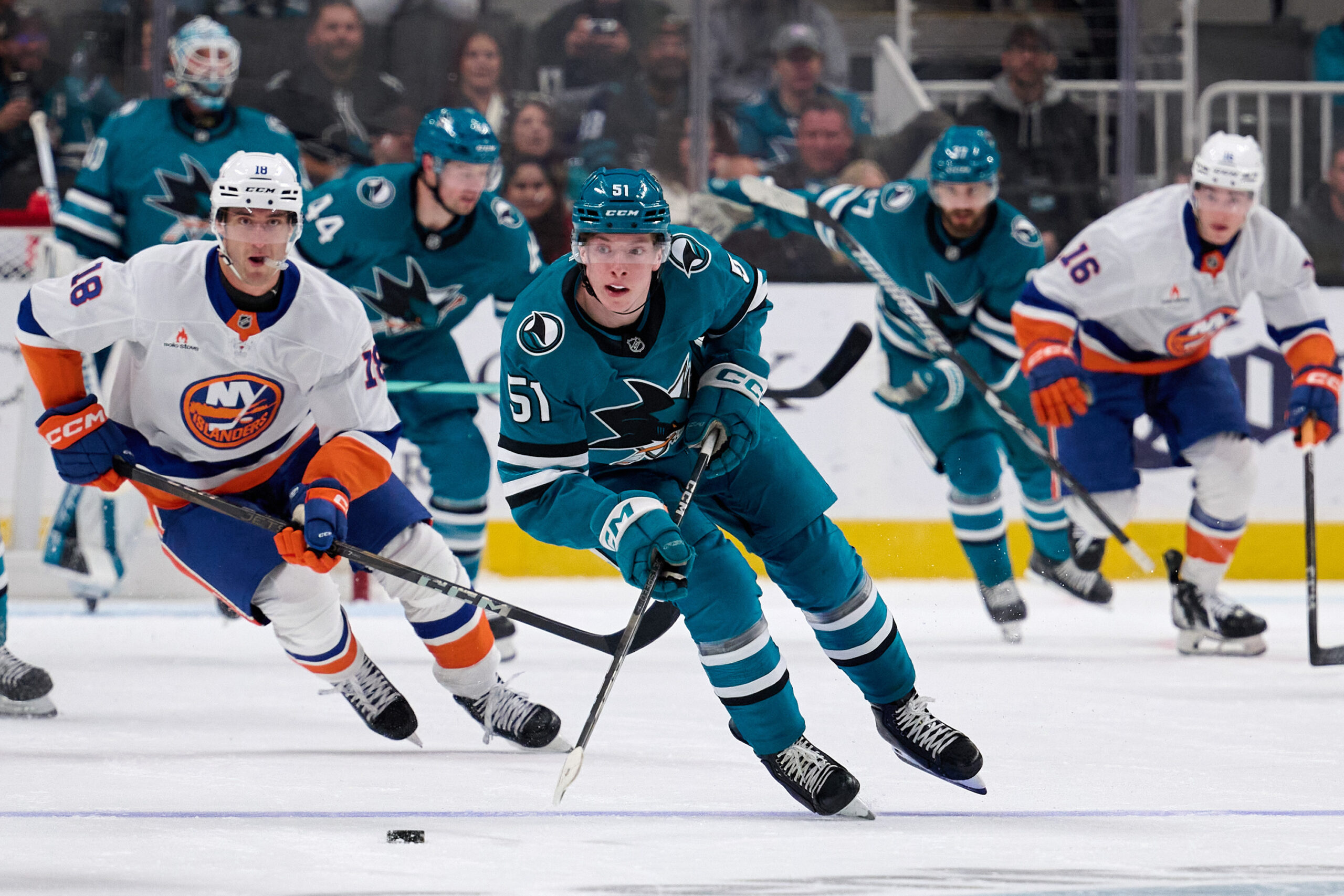 Mar 8, 2025; San Jose, California, USA; San Jose Sharks right wing Collin Graf (51) skates with the puck against New York Islanders left wing Pierre Engvall (18) during the second period at SAP Center at San Jose. Mandatory Credit: Robert Edwards-Imagn Images