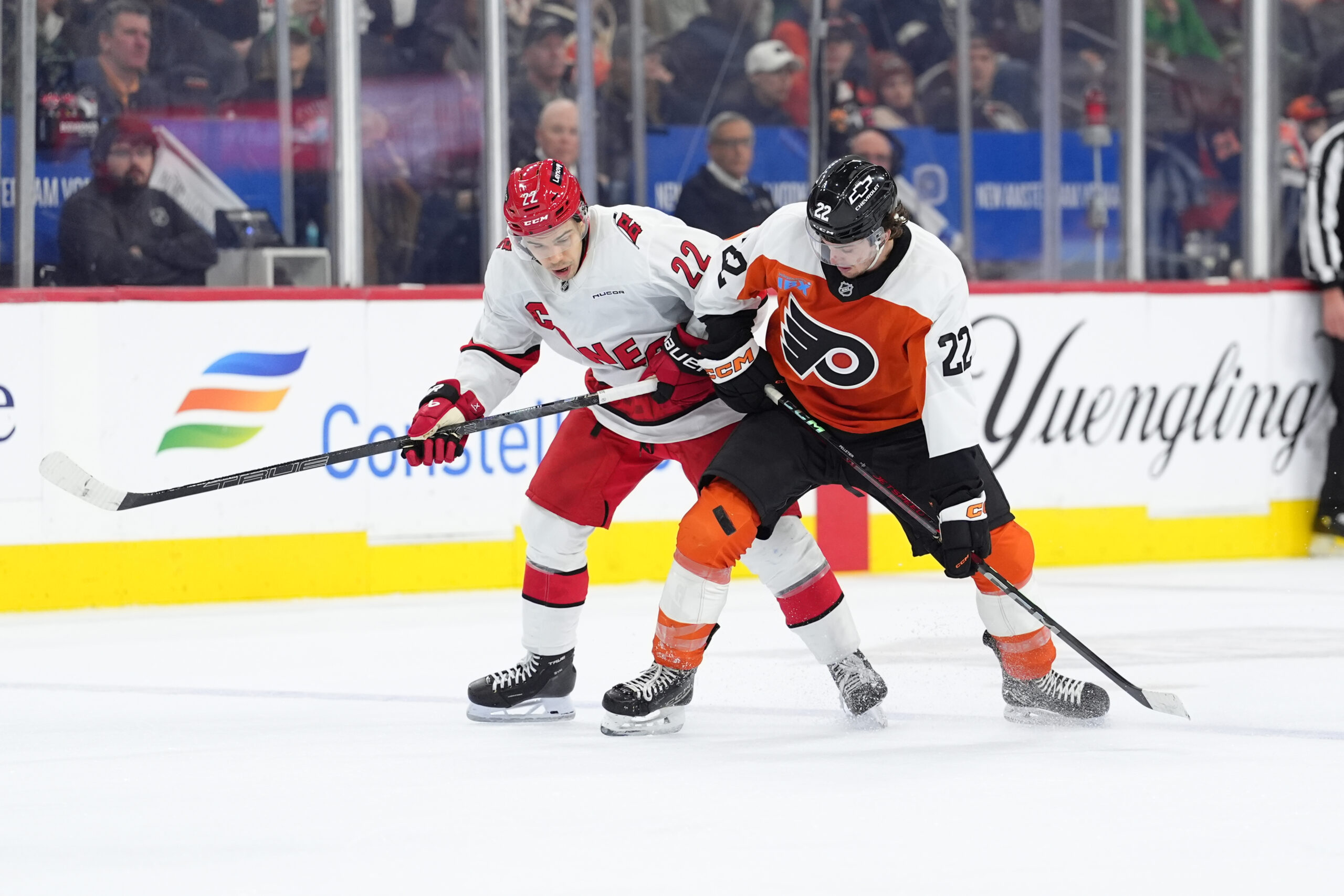 Mar 15, 2025; Philadelphia, Pennsylvania, USA; Carolina Hurricanes center Logan Stankoven (22) and Philadelphia Flyers left wing Jakob Pelletier (22) battle for the puck in the second period at Wells Fargo Center. Mandatory Credit: Kyle Ross-Imagn Images