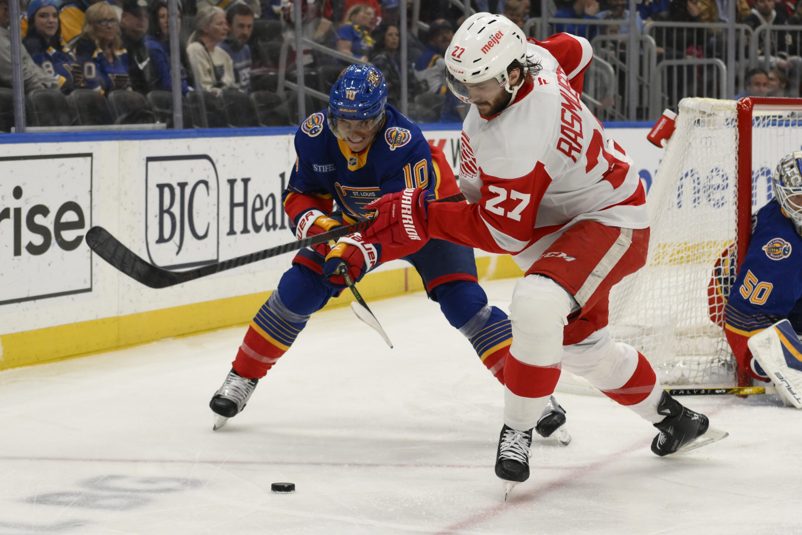 Apr 1, 2025; St. Louis, Missouri, USA; St. Louis Blues center Brayden Schenn (10) battles Detroit Red Wings center Michael Rasmussen (27) during the first period at Enterprise Center. Mandatory Credit: Jeff Le-Imagn Images