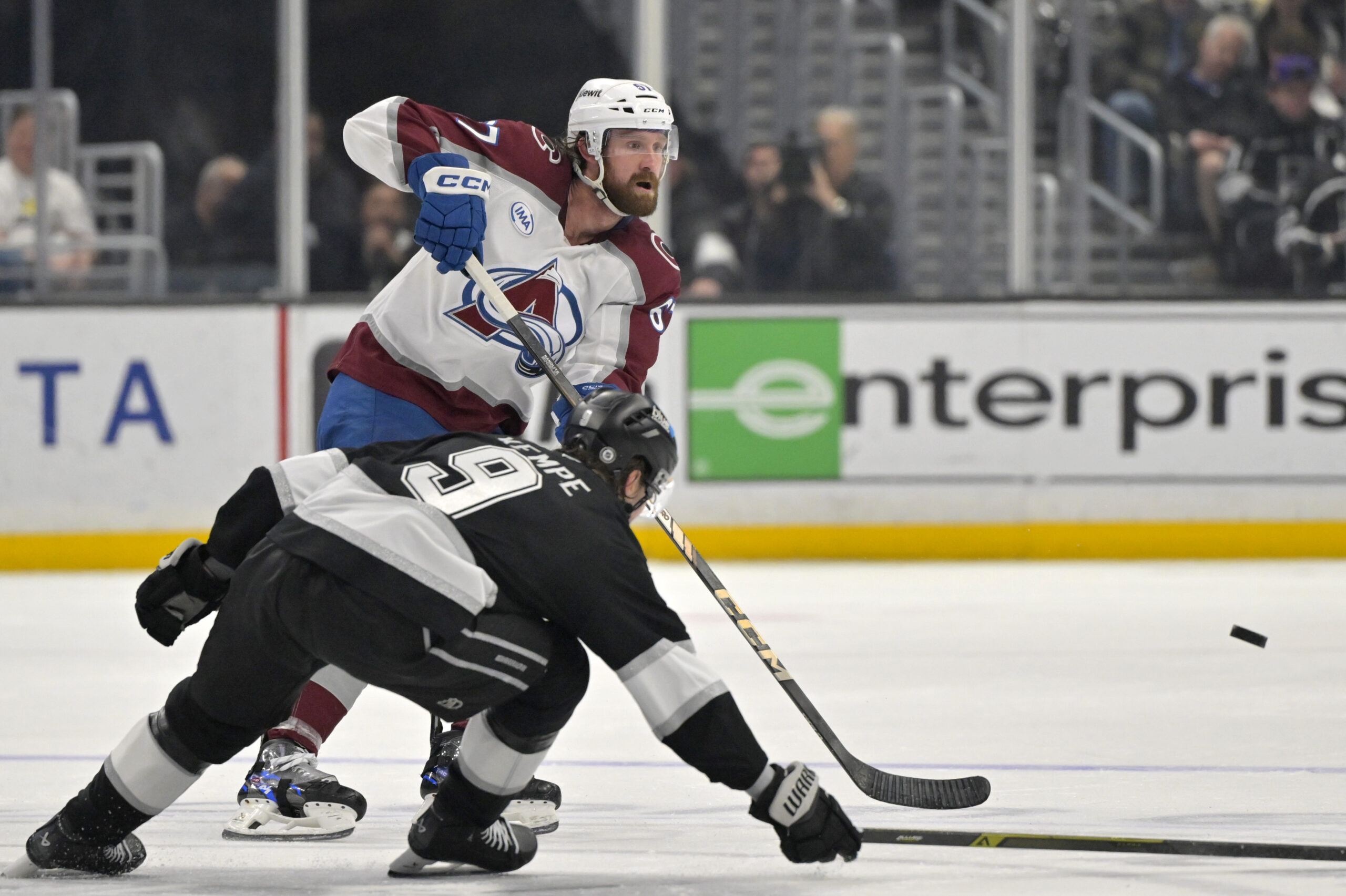 Apr 12, 2025; Los Angeles, California, USA; Los Angeles Kings right wing Adrian Kempe (9) defends a pass by Colorado Avalanche defenseman Keaton Middleton (67) during the third period at Crypto.com Arena. Mandatory Credit: Jayne Kamin-Oncea-Imagn Images