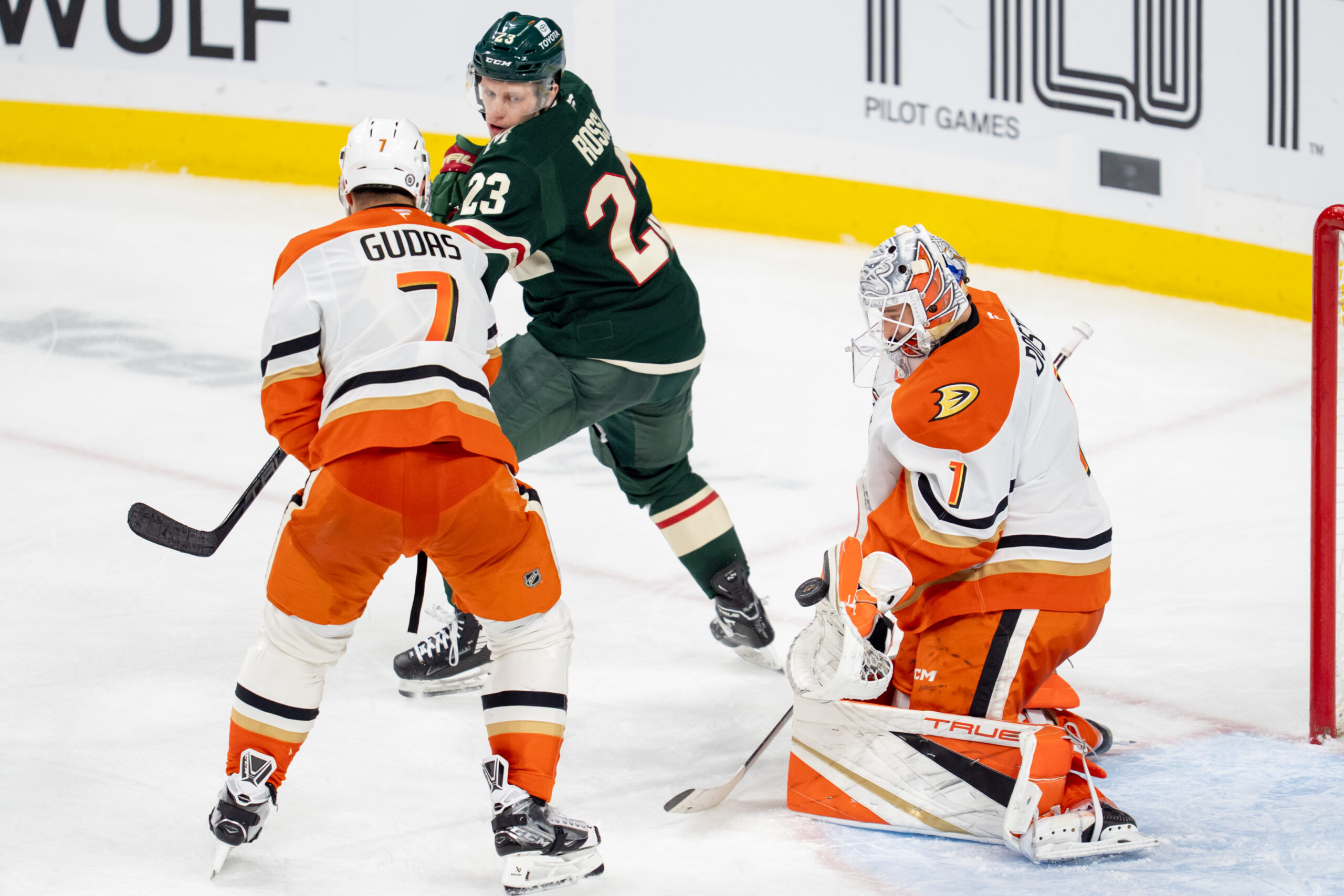 Apr 15, 2025; Saint Paul, Minnesota, USA; Anaheim Ducks goaltender Lukas Dostal (1) makes a save with defenseman Radko Gudas (7) and Minnesota Wild center Marco Rossi (23) fighting for position in front of him in the third period at Xcel Energy Center. Mandatory Credit: Matt Blewett-Imagn Images