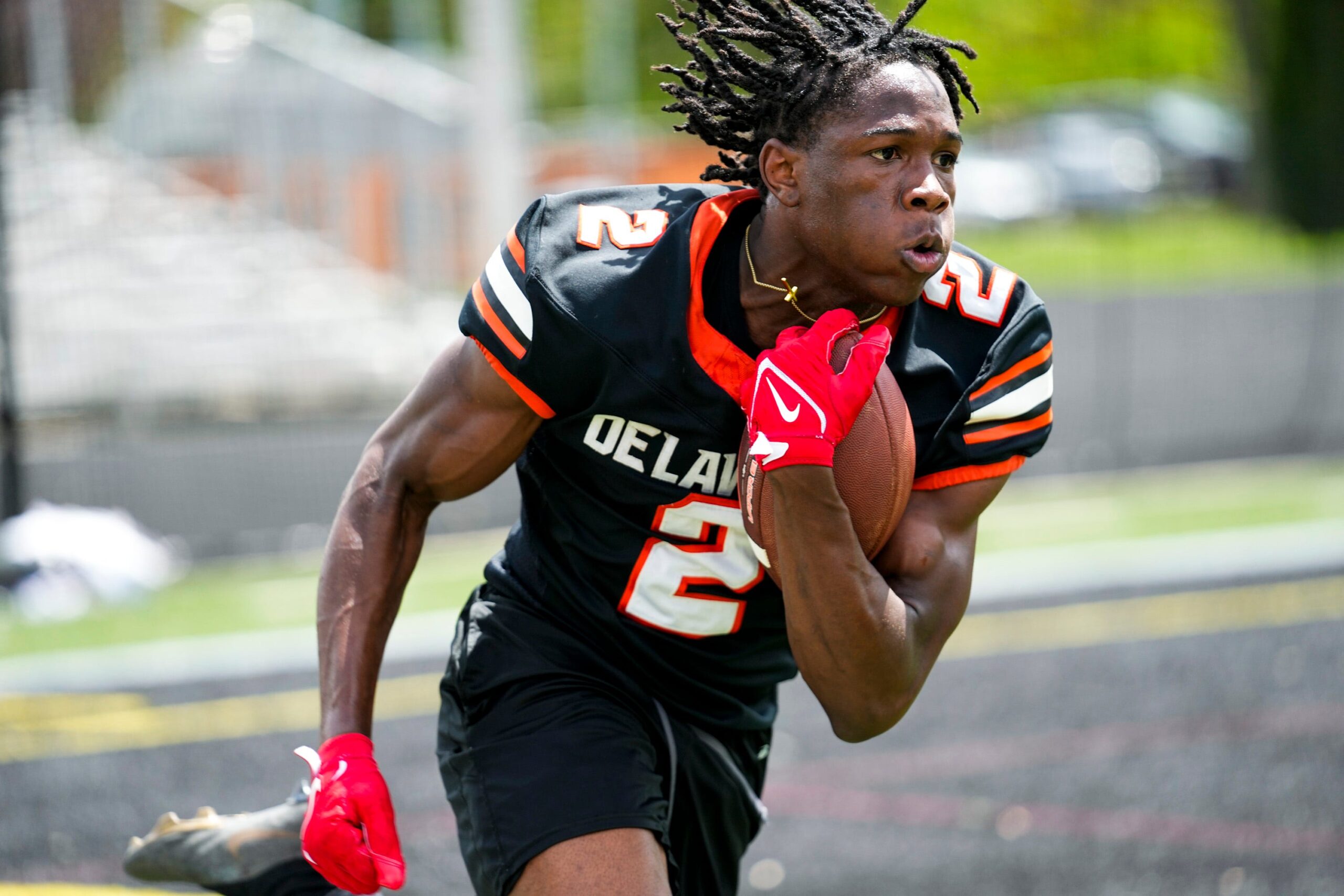 Delaware Hayes’s Favour Akih (2) runs the ball during the college football showcase at the Delaware Hayes High School on Wednesday, May 7, 2025 in Delaware, Ohio.