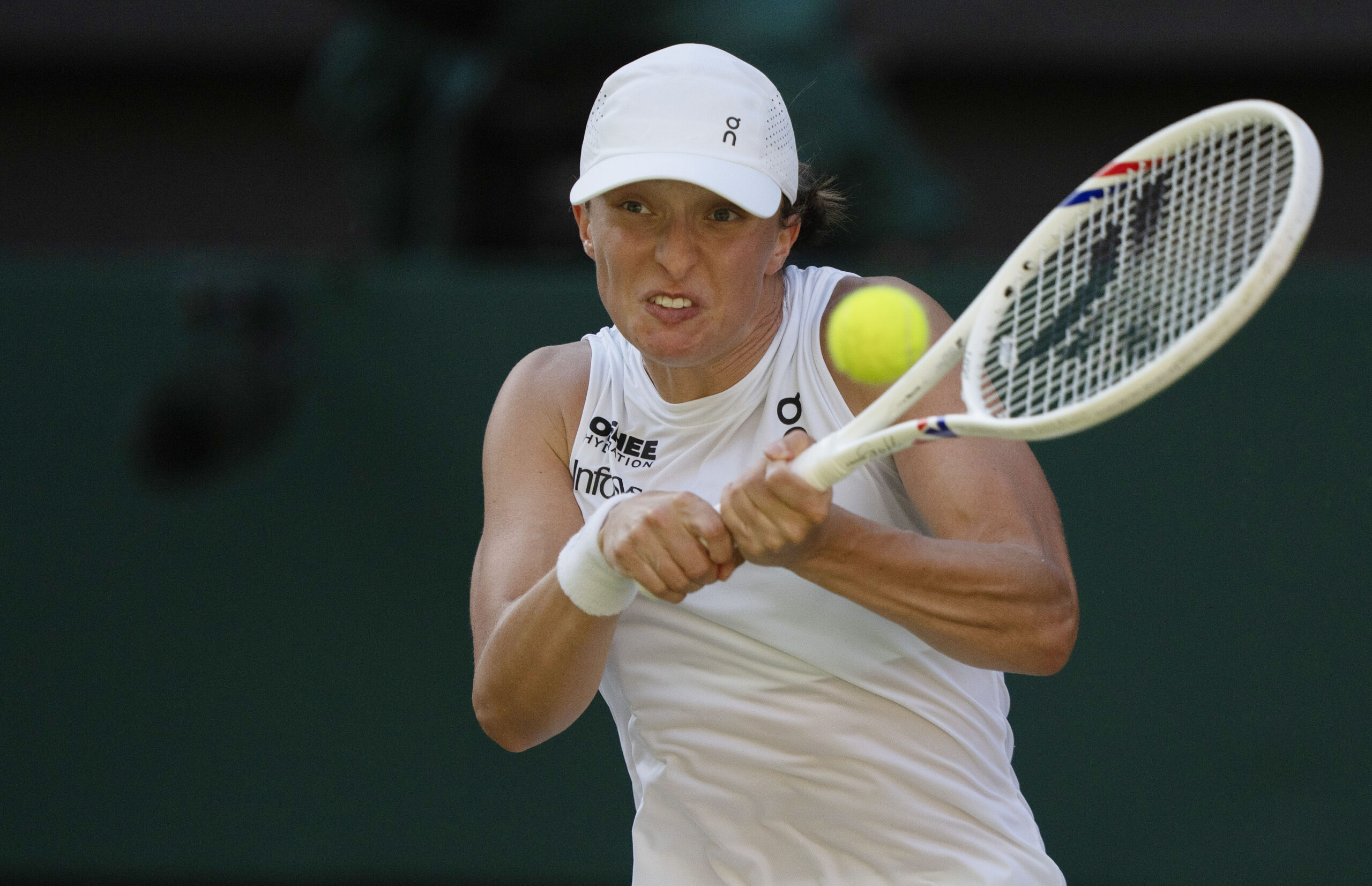 Jul 10, 2025; Wimbledon, United Kingdom; Iga Swiatek of Poland returns a shot during her match against Belinda Bencic of Switzerland on day 11 at All England Lawn Tennis and Croquet Club. Mandatory Credit: Susan Mullane-Imagn Images