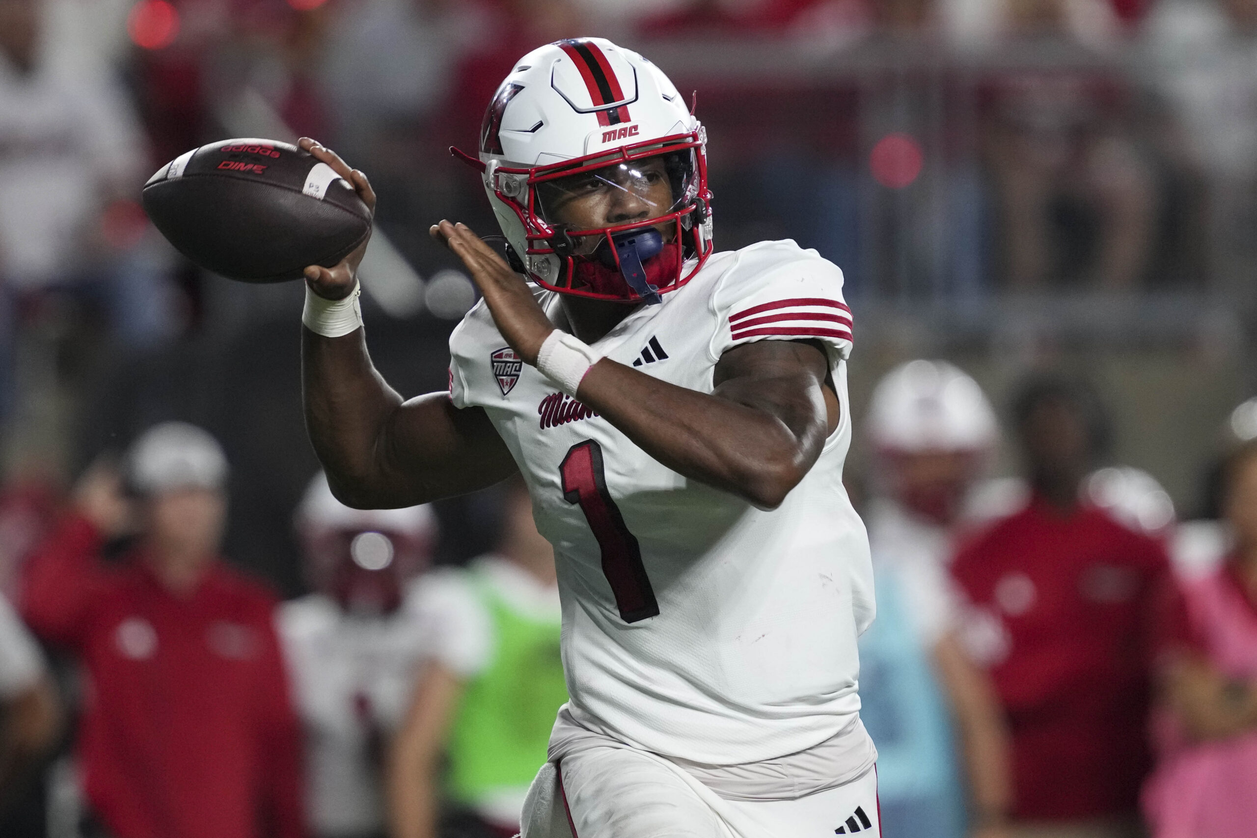 Aug 28, 2025; Madison, Wisconsin, USA; Miami (OH) RedHawks quarterback Dequan Finn (1) throws a pass during the third quarter against the Wisconsin Badgers at Camp Randall Stadium. Mandatory Credit: Jeff Hanisch-Imagn Images