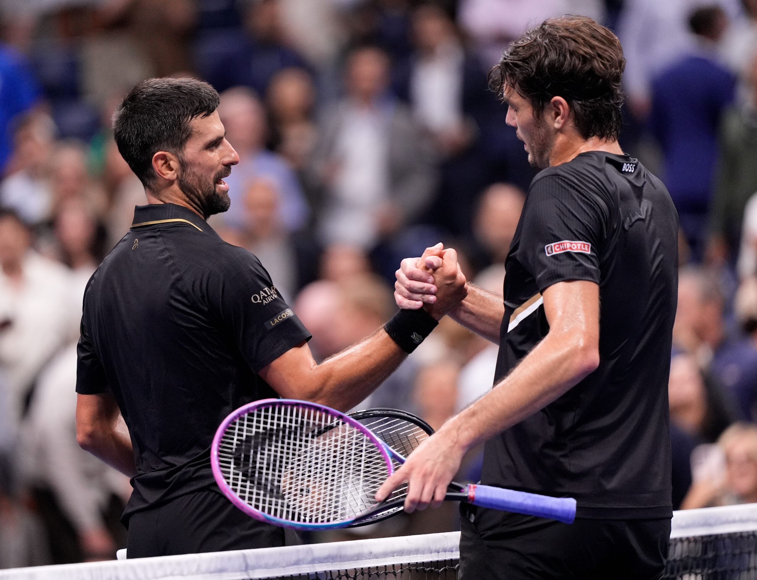 Sep 2, 2025; Flushing, NY, USA;  Novak Djokovic (SRB) (left) after defeating Taylor Fritz (USA) (right) on day ten of the 2025 U.S. Open tennis tournament at the USTA Billie Jean King National Tennis Center. Mandatory Credit: Robert Deutsch-Imagn Images