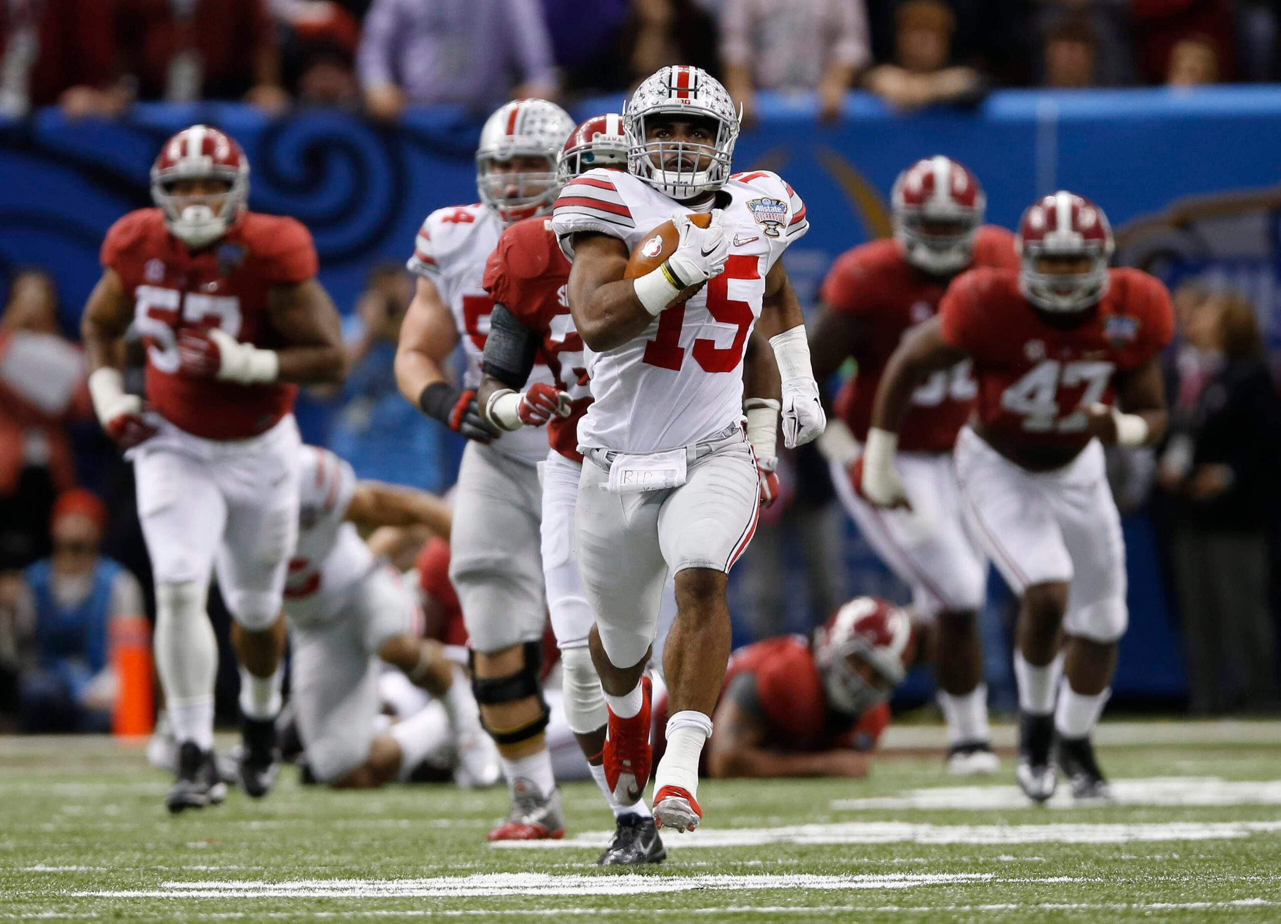 Ohio State Buckeyes running back Ezekiel Elliott (15) runs for an 85-yard touchdown in the fourth quarter of the Allstate Sugar Bowl college football playoff semifinal against the Alabama Crimson Tide at the Mercedes-Benz Superdome in New Orleans on Jan. 1, 2015. (Adam Cairns / The Columbus Dispatch)