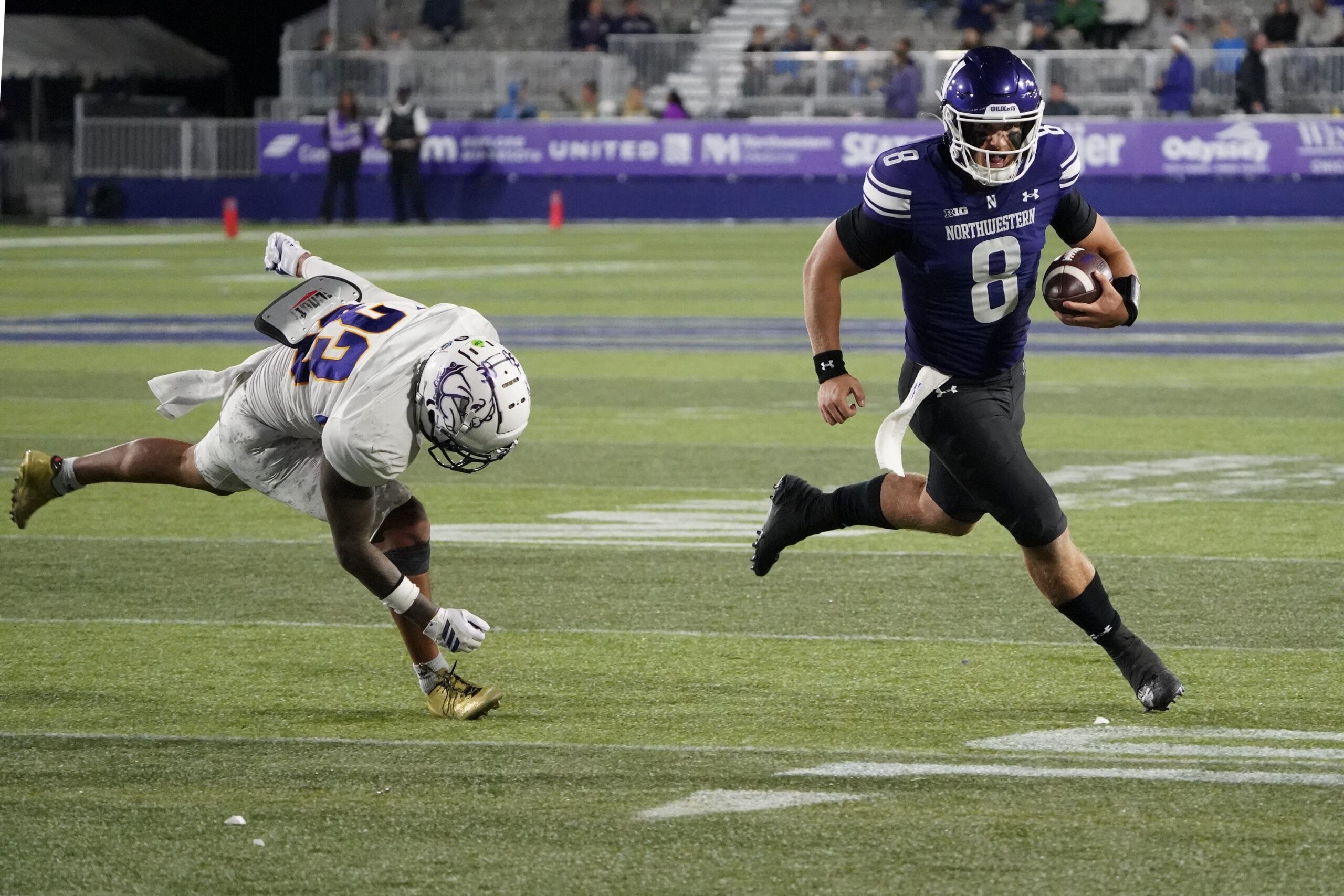 Sep 5, 2025; Evanston, Illinois, USA; Western Illinois Leathernecks defensive back Malini Ti'a (33) defends Northwestern Wildcats quarterback Preston Stone (8) during the second half at Northwestern Medicine Field at Martin Stadium. Mandatory Credit: David Banks-Imagn Images