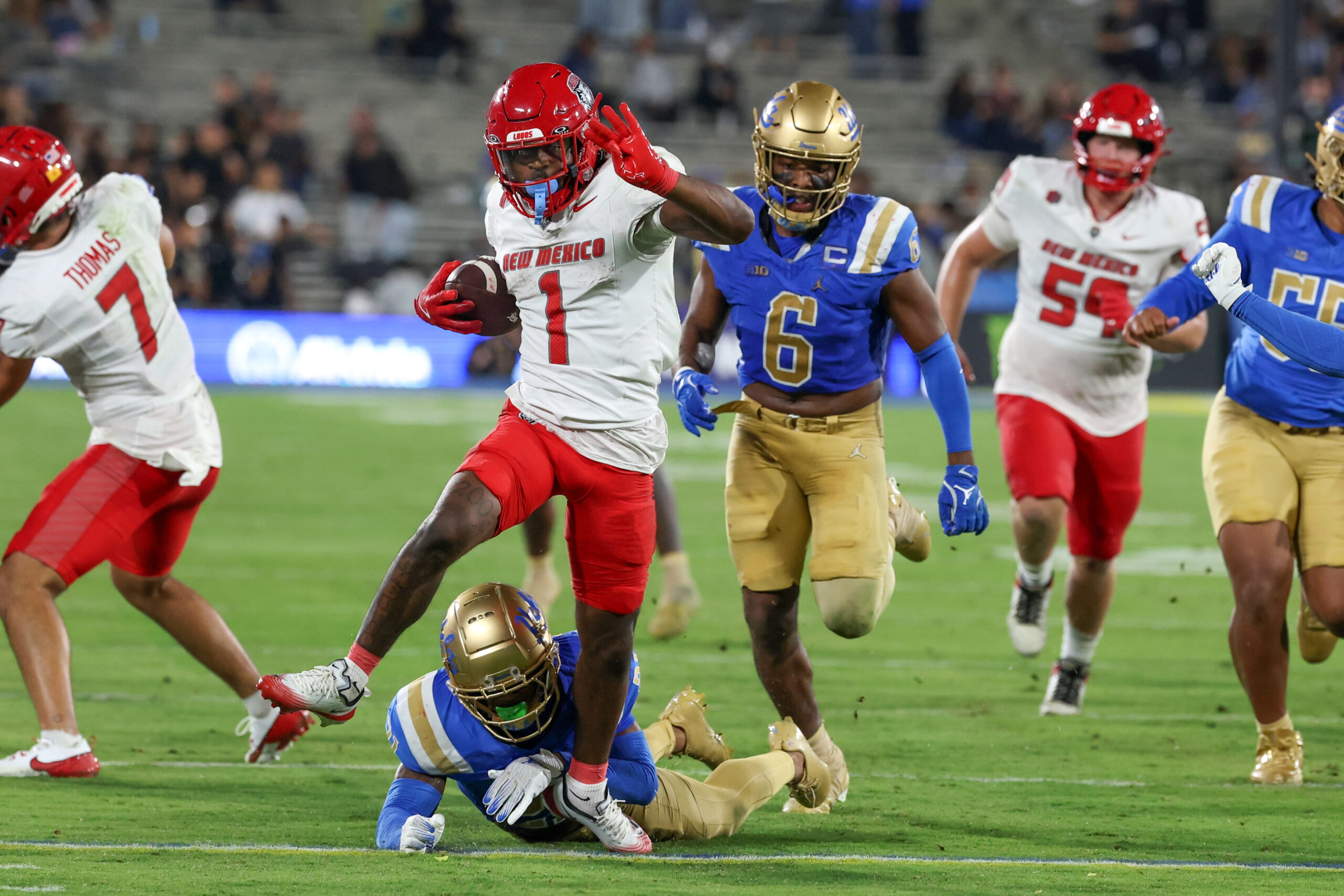 Sep 12, 2025; Pasadena, California, USA;  New Mexico Lobos running back Damon Bankston (1) runs with the ball for a  touchdown during the fourth quarter against the UCLA Bruins at Rose Bowl. Mandatory Credit: Kiyoshi Mio-Imagn Images