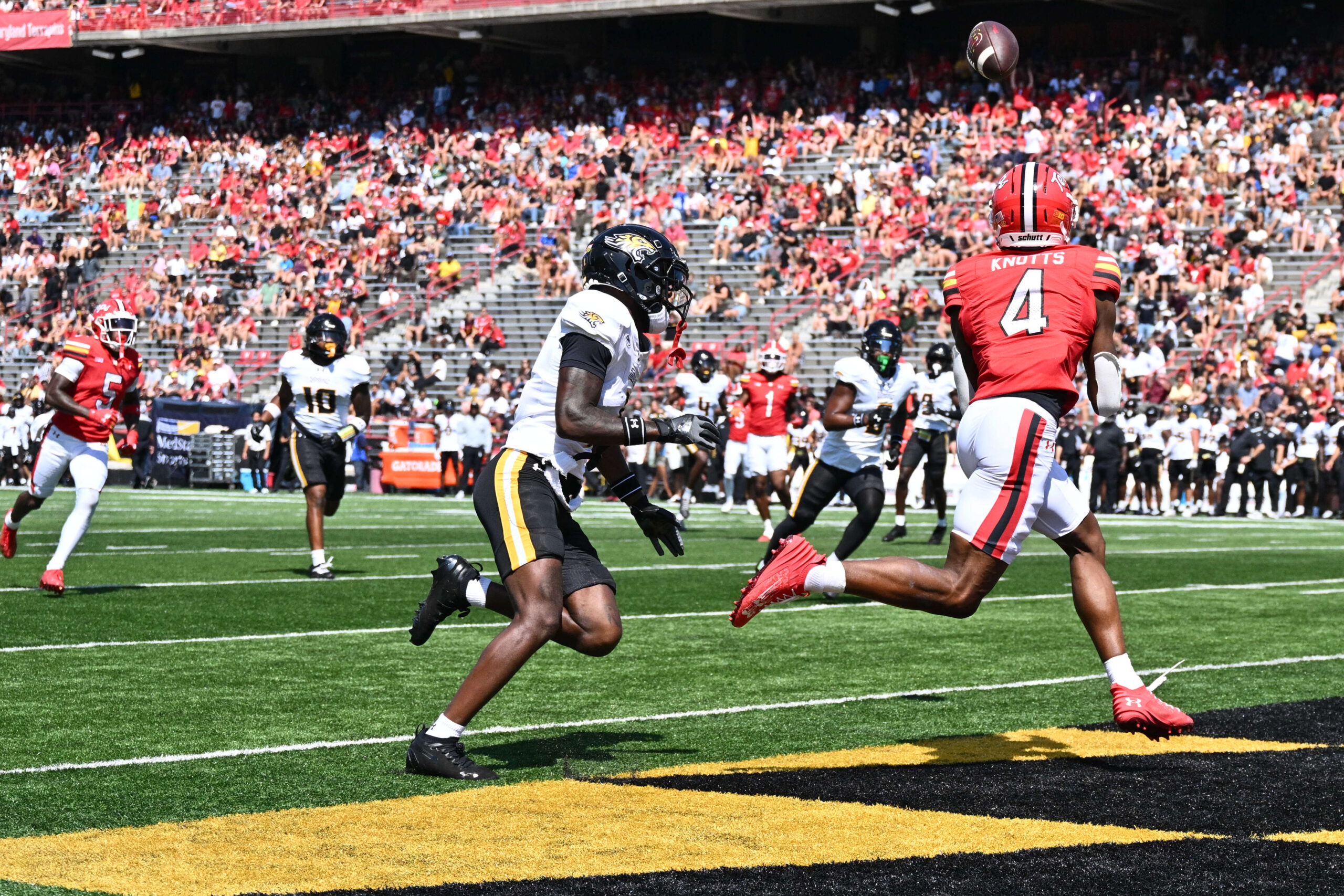Sep 13, 2025; College Park, Maryland, USA;  Maryland Terrapins wide receiver Shaleak Knotts (4) catches a touchdown pass in the first half against the Towson Tigers at SECU Stadium. Mandatory Credit: Jamie Sabau-Imagn Images