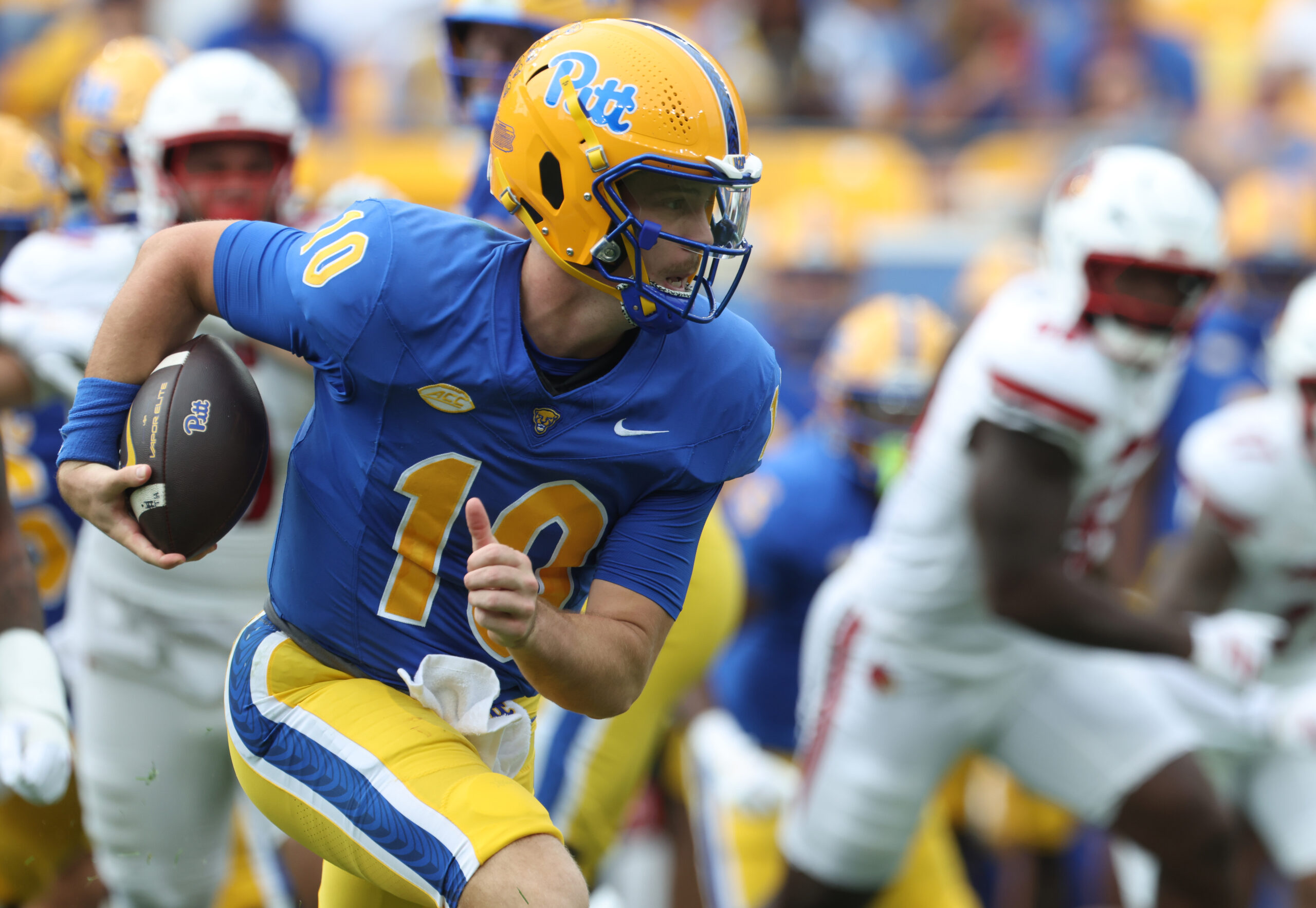 Sep 27, 2025; Pittsburgh, Pennsylvania, USA;  Pittsburgh Panthers quarterback Eli Holstein (10) runs the ball against the Louisville Cardinals during the second quarter at Acrisure Stadium. Mandatory Credit: Charles LeClaire-Imagn Images