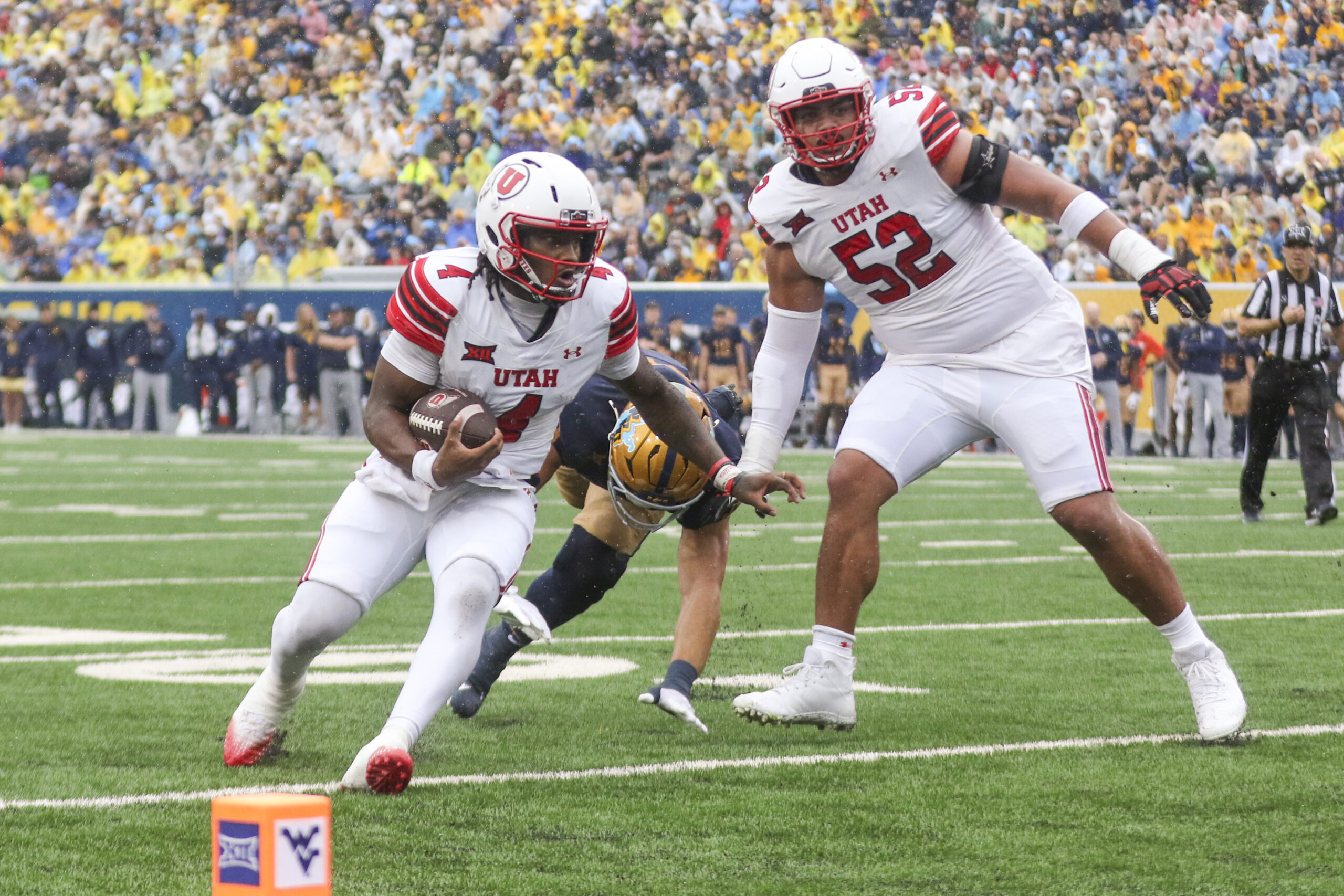 Sep 27, 2025; Morgantown, West Virginia, USA; Utah Utes quarterback Devon Dampier (4) runs the ball for a touchdown during the first quarter against the West Virginia Mountaineers at Milan Puskar Stadium. Mandatory Credit: Ben Queen-Imagn Images