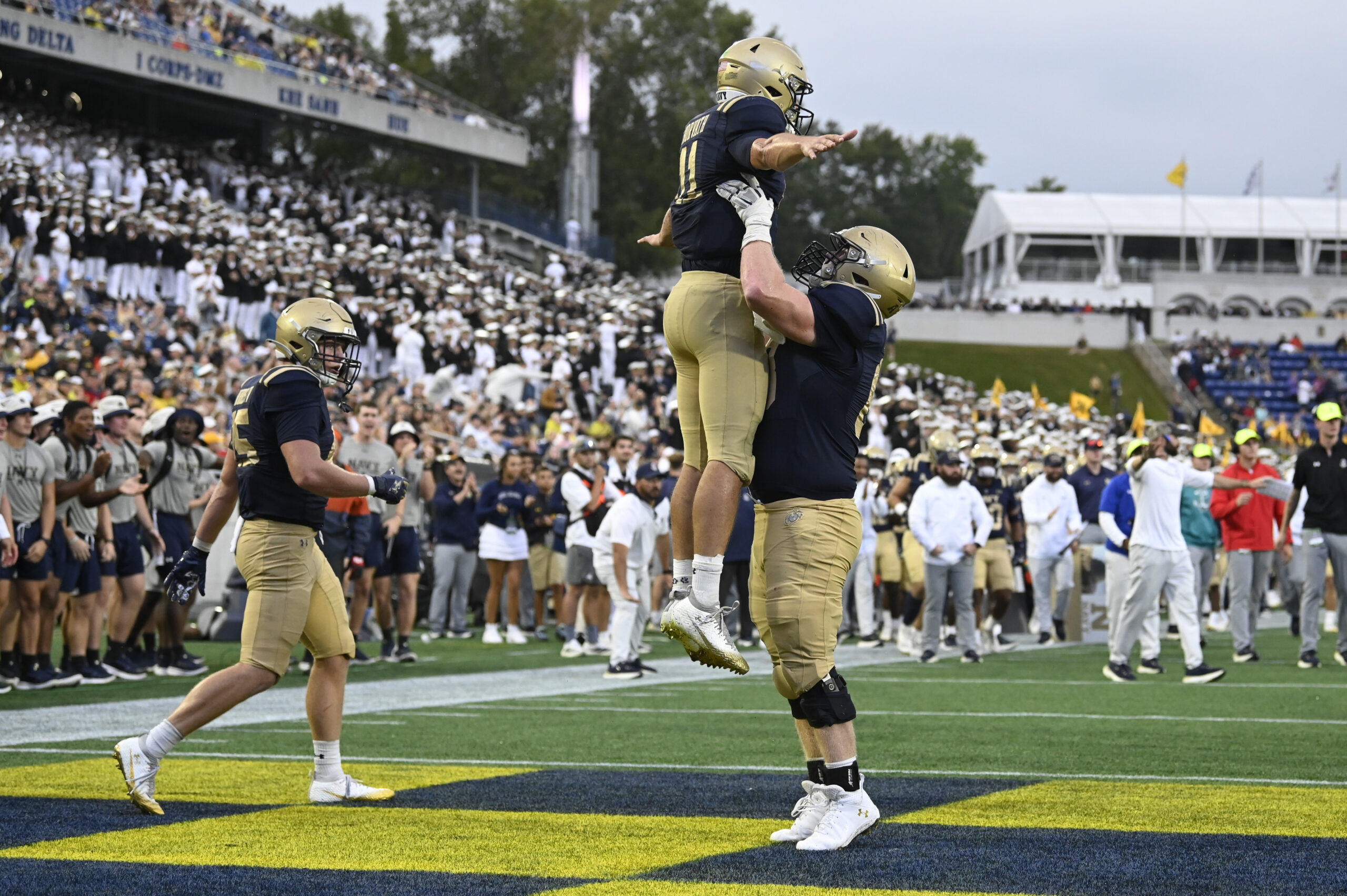 Sep 27, 2025; Annapolis, Maryland, USA; Navy Midshipmen quarterback Blake Horvath (11) celebrates with guard Jaylin Acevedo (66) after scoring a fourth quarter touchdown against the Rice Owls at Navy-Marine Corps Memorial Stadium. Mandatory Credit: Tommy Gilligan-Imagn Images