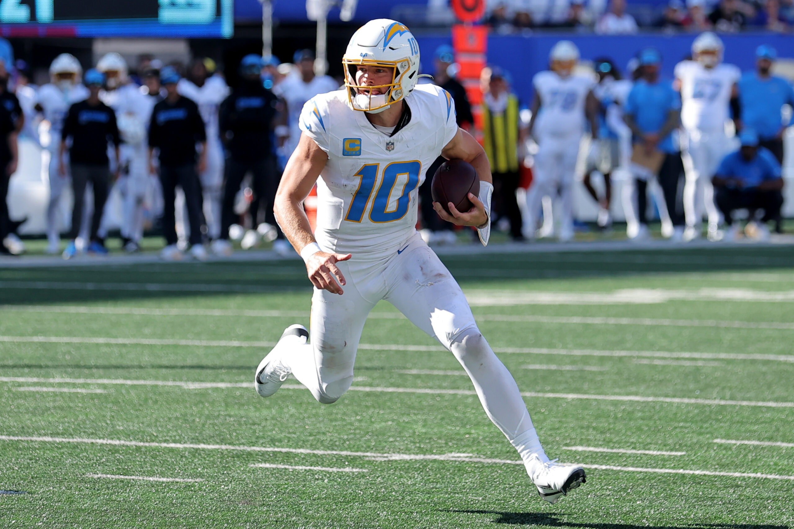 Sep 28, 2025; East Rutherford, New Jersey, USA; Los Angeles Chargers quarterback Justin Herbert (10) runs with the ball against the New York Giants during the third quarter at MetLife Stadium. Mandatory Credit: Brad Penner-Imagn Images